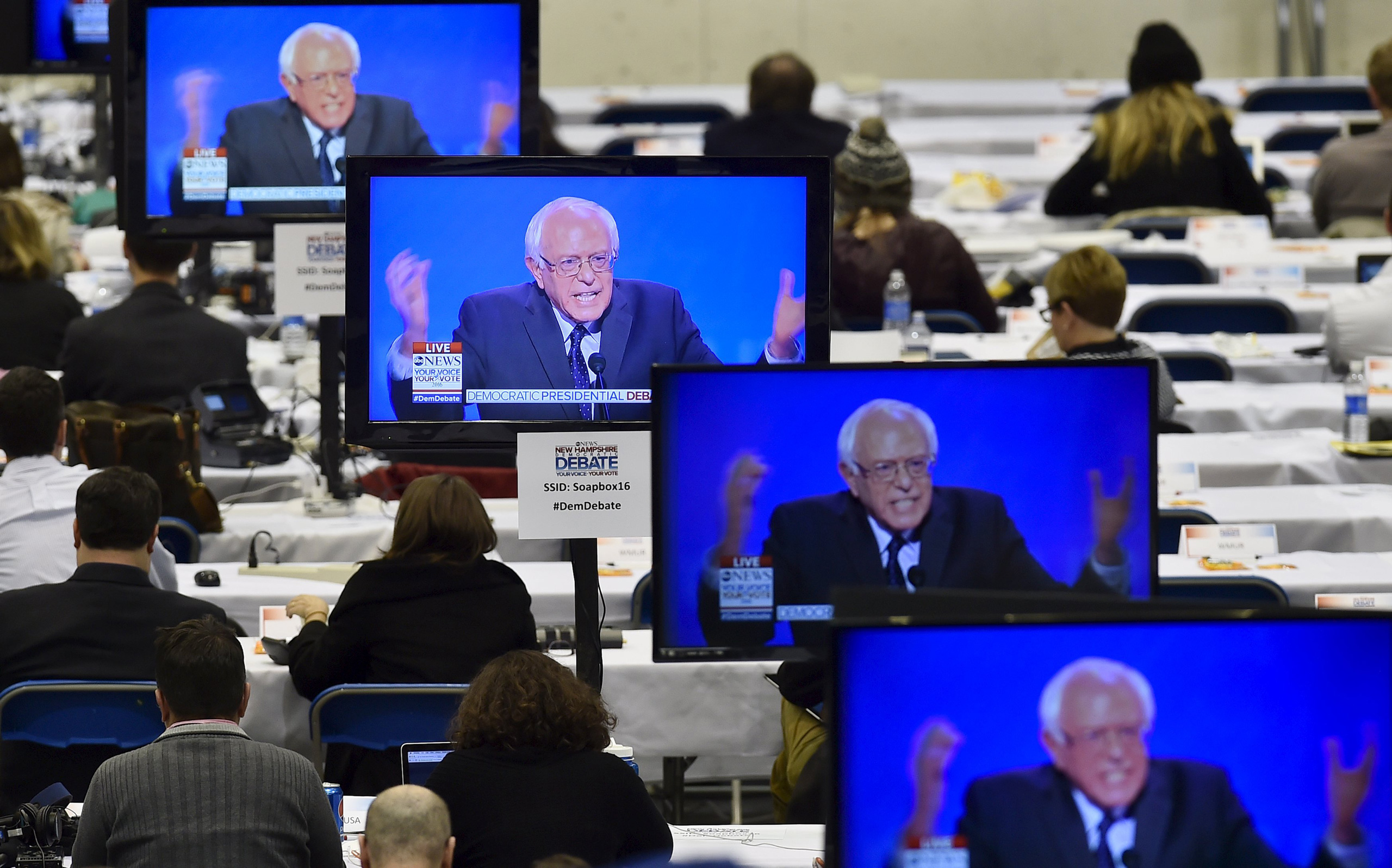 U.S. Democratic presidential candidate Bernie Sanders appears on television screens in the media work-room during the Democratic presidential candidates debate at Saint Anselm College in Manchester, New Hampshire December 19, 2015.      REUTERS/Gretchen Ertl      TPX IMAGES OF THE DAY