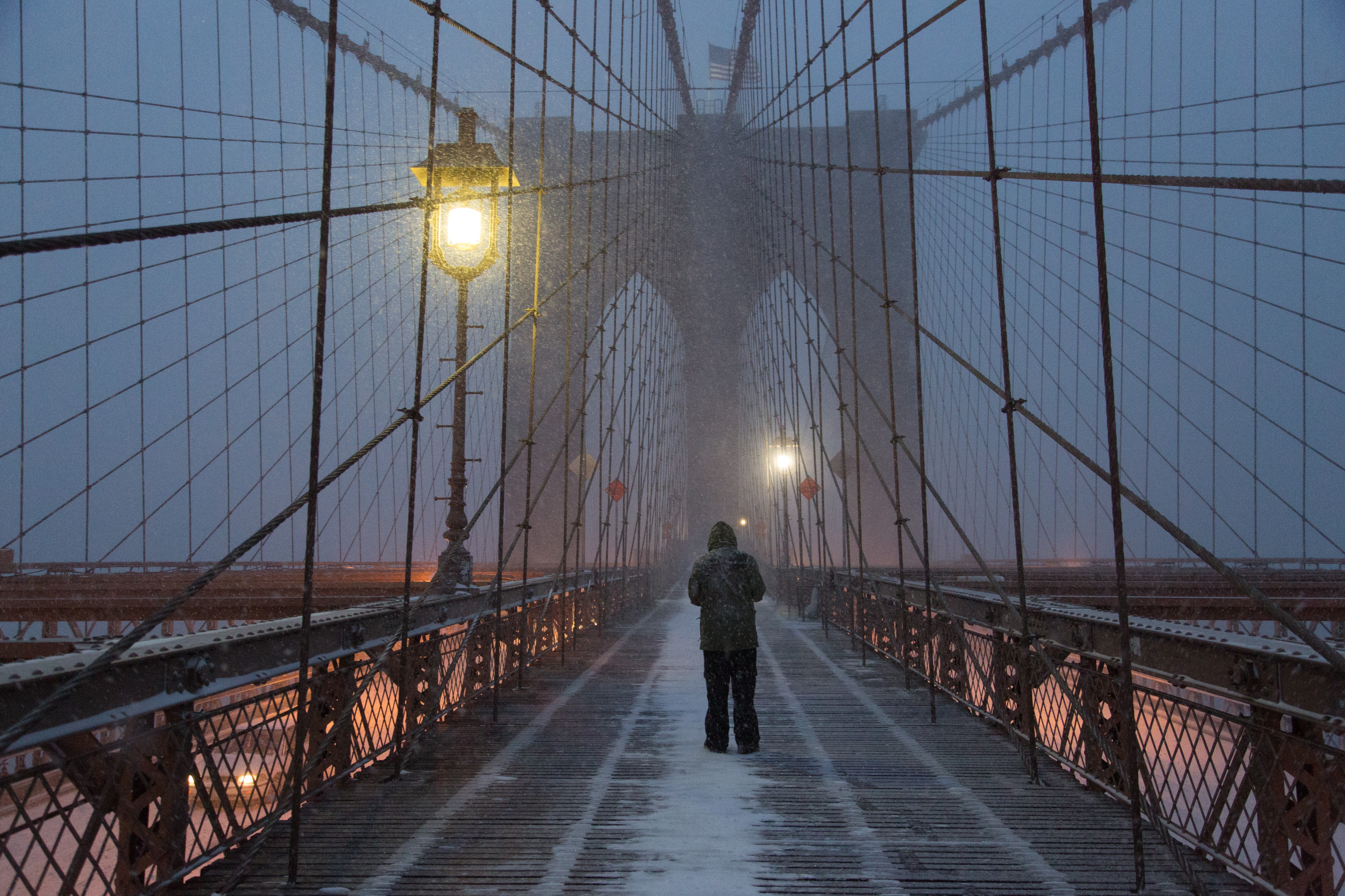 A New Yorker braves the Brooklyn Bridge in New York City on Jan. 23, 2016.