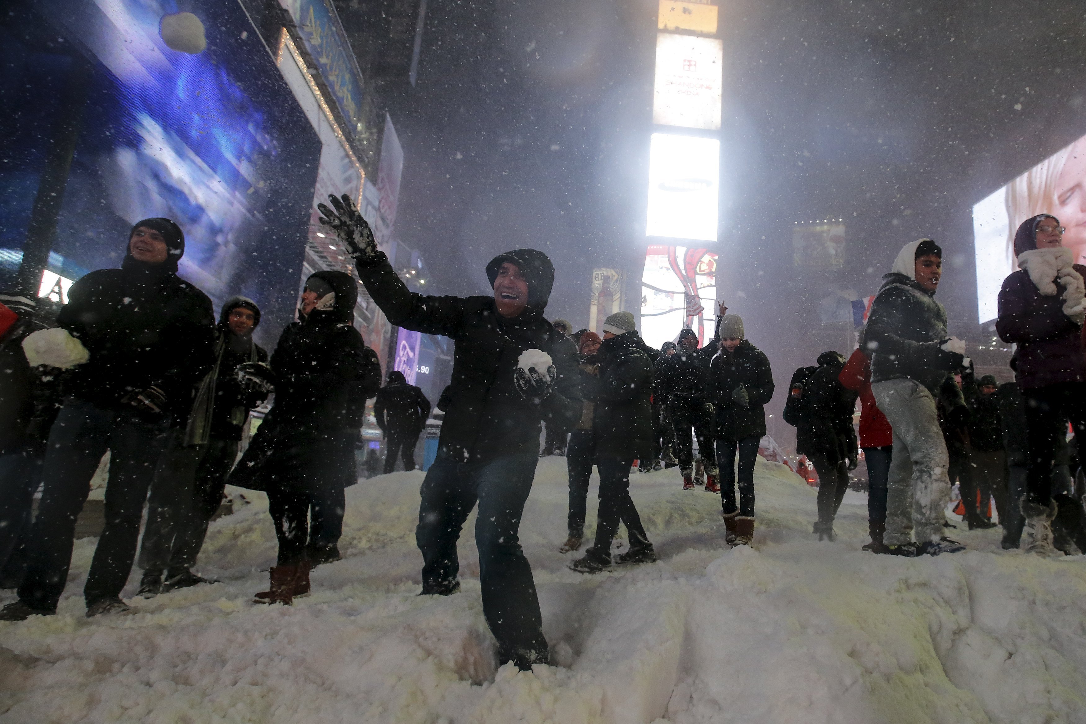 Dozens of people take part in an impromptu snow ball fight in Times Square in New York City on Jan. 23, 2016.