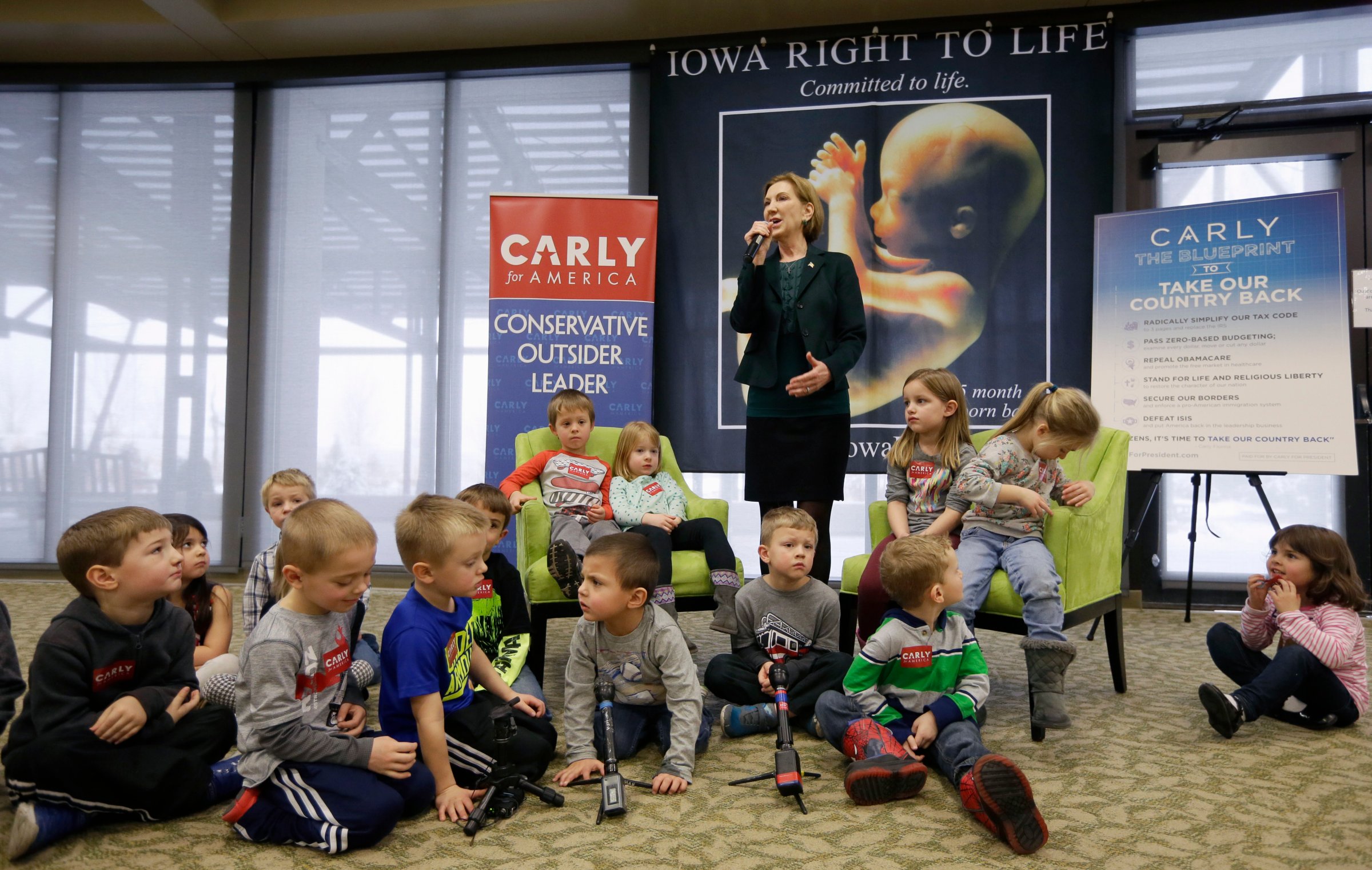 Republican presidential candidate Carly Fiorina is surrounded by preschool students as she speaks during the Iowa Right to Life Presidential Forum in Des Moines, Iowa on Jan. 20, 2016.