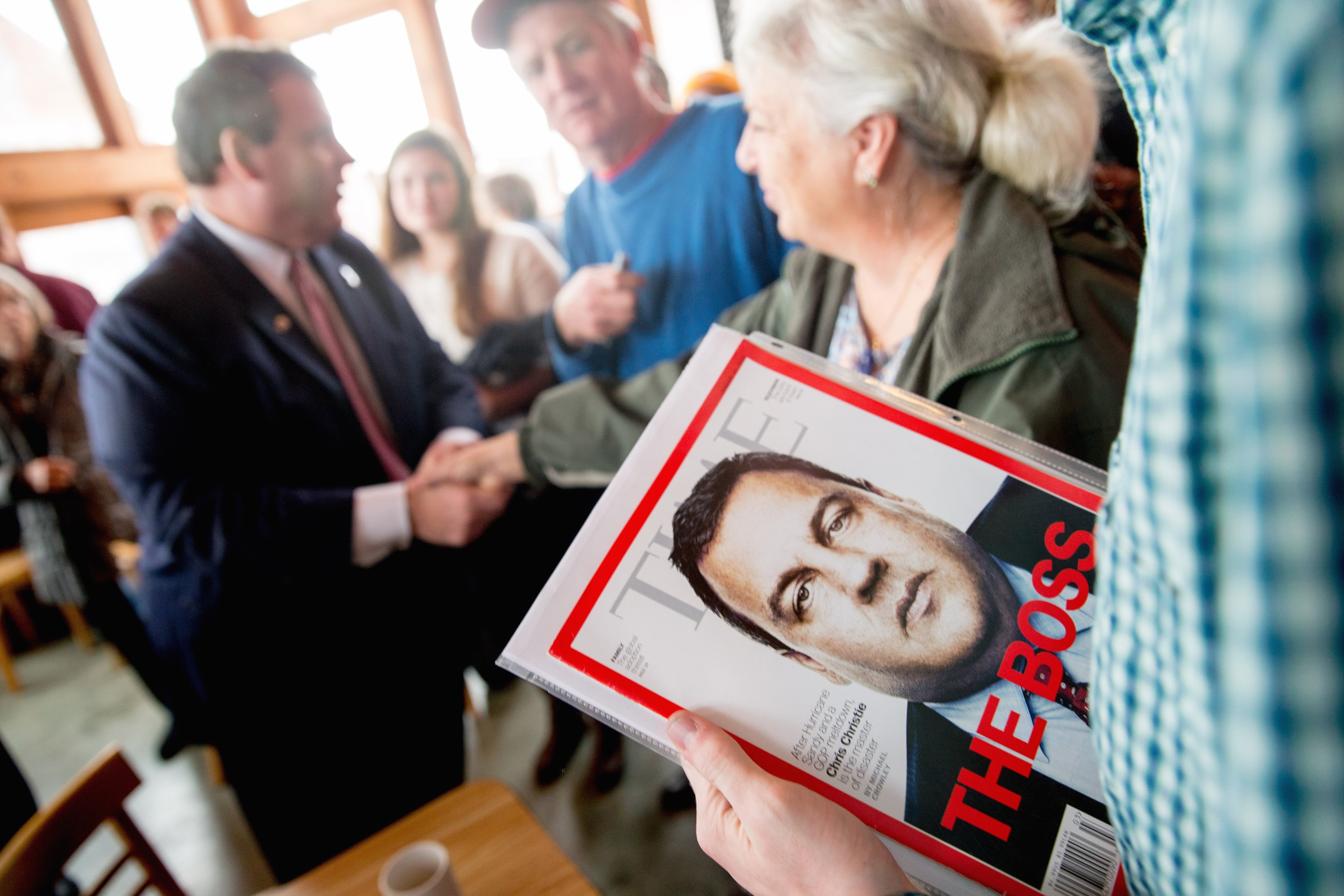 A visitor holds a Time Magazine depicting Republican presidential candidate, New Jersey Gov. Chris Christie after he spoke at Elly's Tea and Coffee House in Muscatine, Iowa, Tuesday, Dec. 29, 2015. (Andrew Harnik—AP)