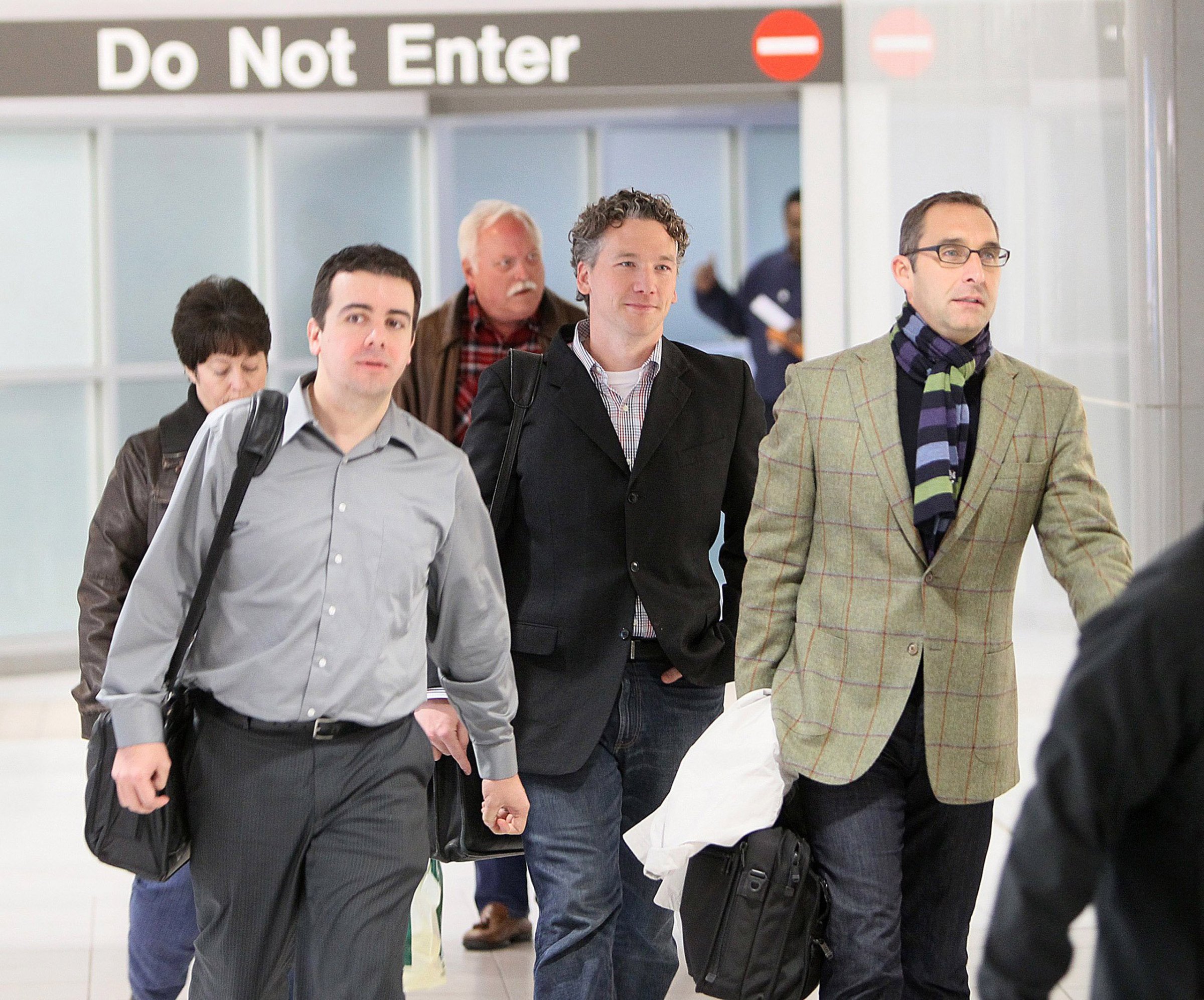 In this Dec. 8, 2011, photo, then-St. Louis Cardinals scouting director Christopher Correa, left, assistant general manager Mike Girsch, center, and general manager John Mozeliak, right, arrive at Lambert-St. Louis International Airport in St. Louis, Mo., from the baseball winter meetings in Dallas. The former scouting director of the St. Louis Cardinals has pleaded guilty in federal court to hacking the Houston Astros' player personnel database. Christopher Correa pleaded guilty Friday, Jan. 8, 2016, to five counts of unauthorized access of a protected computer, access authorities said dated back several years. The 35-year-old Correa was the Cardinals' director of baseball development until he was fired last summer. (Chris Lee/St. Louis Post-Dispatch via AP) EDWARDSVILLE INTELLIGENCER OUT; THE ALTON TELEGRAPH OUT; MANDATORY CREDIT