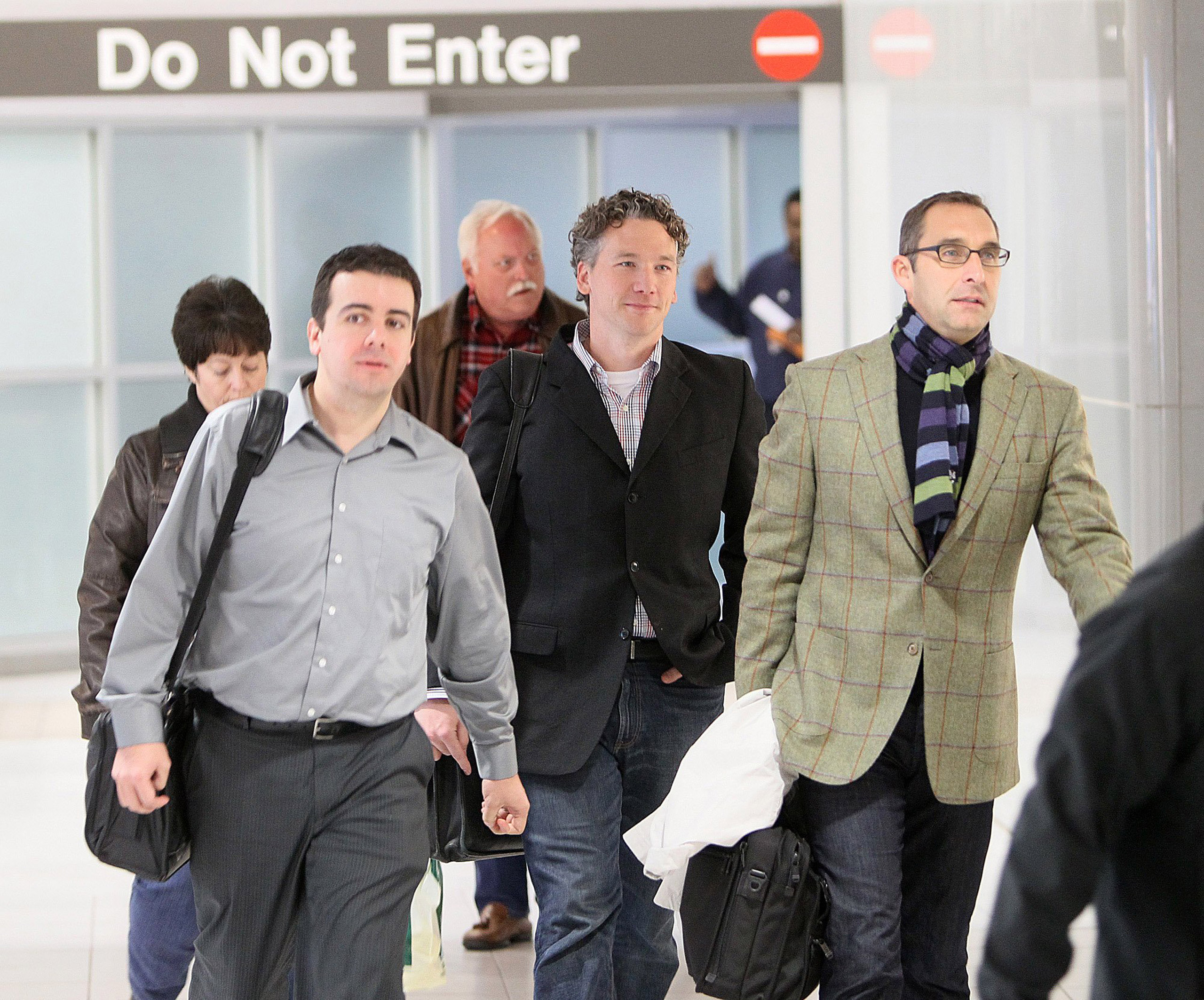 Then-St. Louis Cardinals scouting director Christopher Correa (left), assistant general manager Mike Girsch and general manager John Mozeliak arrive at Lambert-St. Louis International Airport in St. Louis, Mo., on Dec. 8, 2011. (Chris Lee—AP)