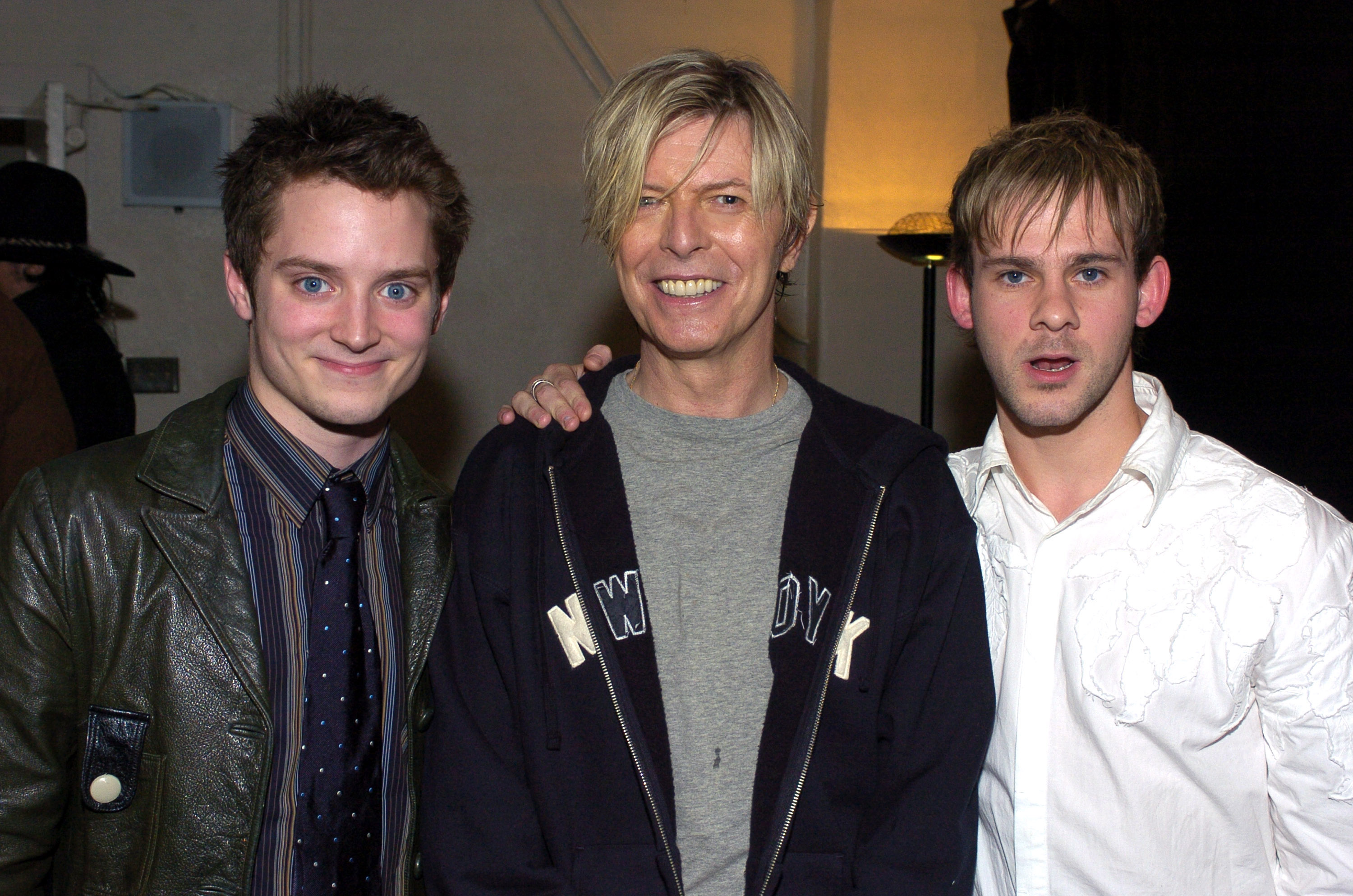 "The Lord of the Rings" Trilogy stars Elijah Wood(L) and Dominic Monaghan (R) with David Bowie seen backstage at BOWIE's first concert visit to Los Angeles in nearly seven years.