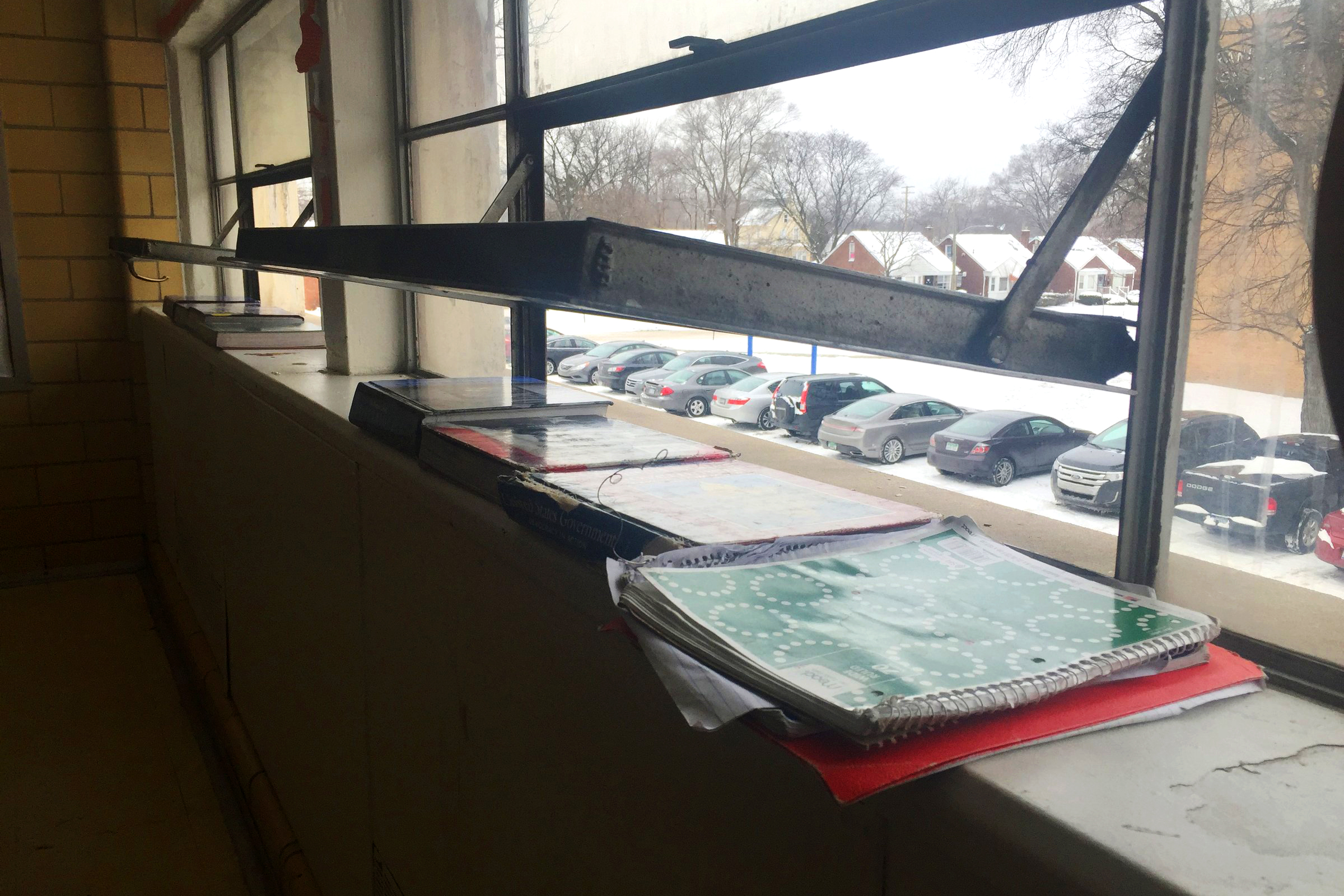 Windows are open and books cover heating vents to keep excessive heat from raising classroom temperatures at Cody Complex, part of the Detroit Public Schools, on Detroit's west side on Jan. 14, 2016. The school's aging boilers need work to regulate the temperature, but the district can't afford to fix them. (John Wisely—Detroit Free Press/Zuma)