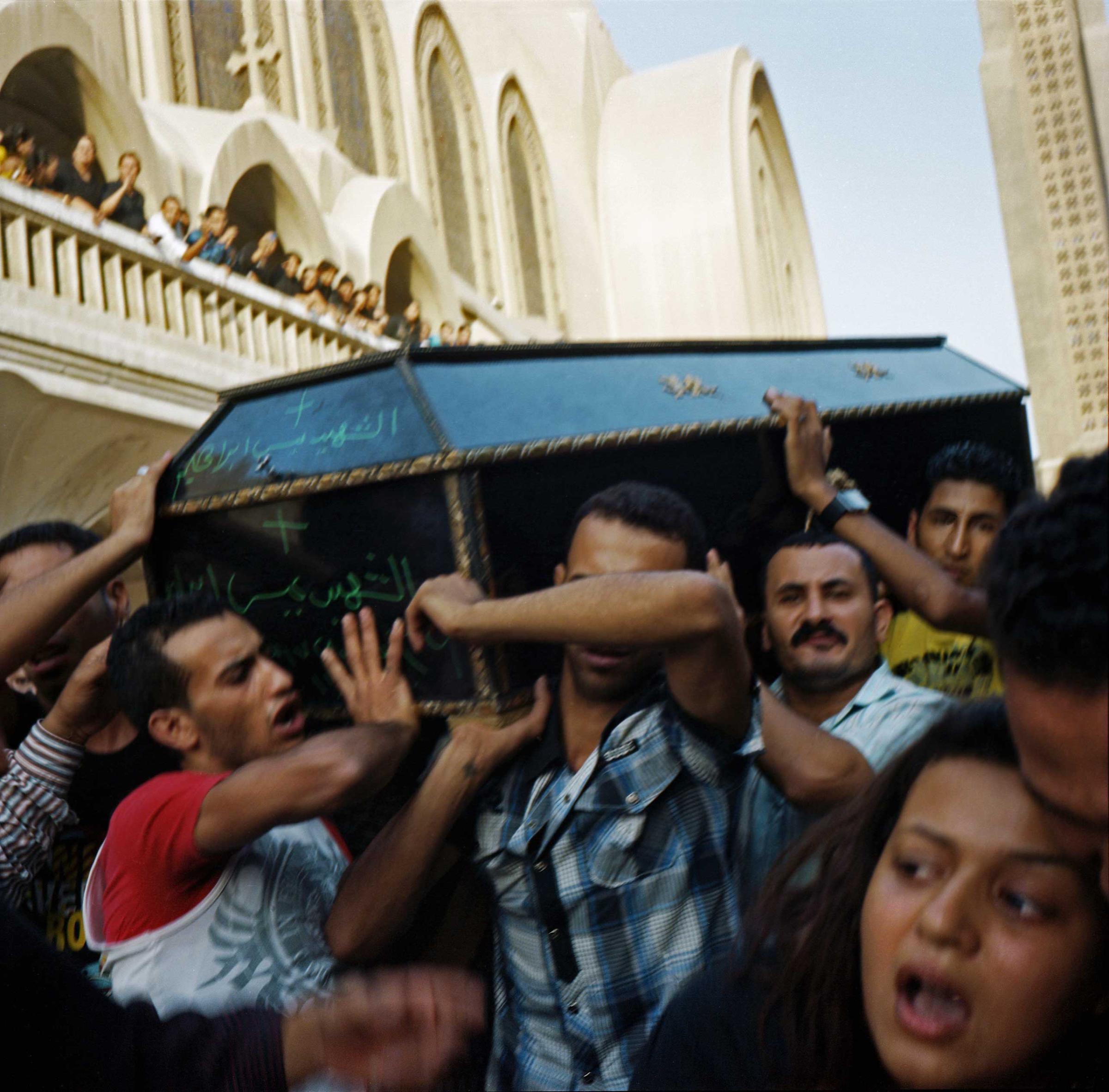 Relatives of victims carrying coffins out of the Abasseya Cathedral to be buried following violence that took place in front of Maspero TV building on October 9 - 10, 2011 resulting in 28 mostly Coptic deaths and 212 injured. The clashes occurred between Copts demonstrating peacefully against an attack on a church in Upper Egypt and the Egyptian Army and security forces. The Coptic demonstration was violently dispersed by tanks and armored vehicles, as well as random shooting in the crowd the night of October 9 - 10, 2011. Cairo, Egypt. October 10, 2011