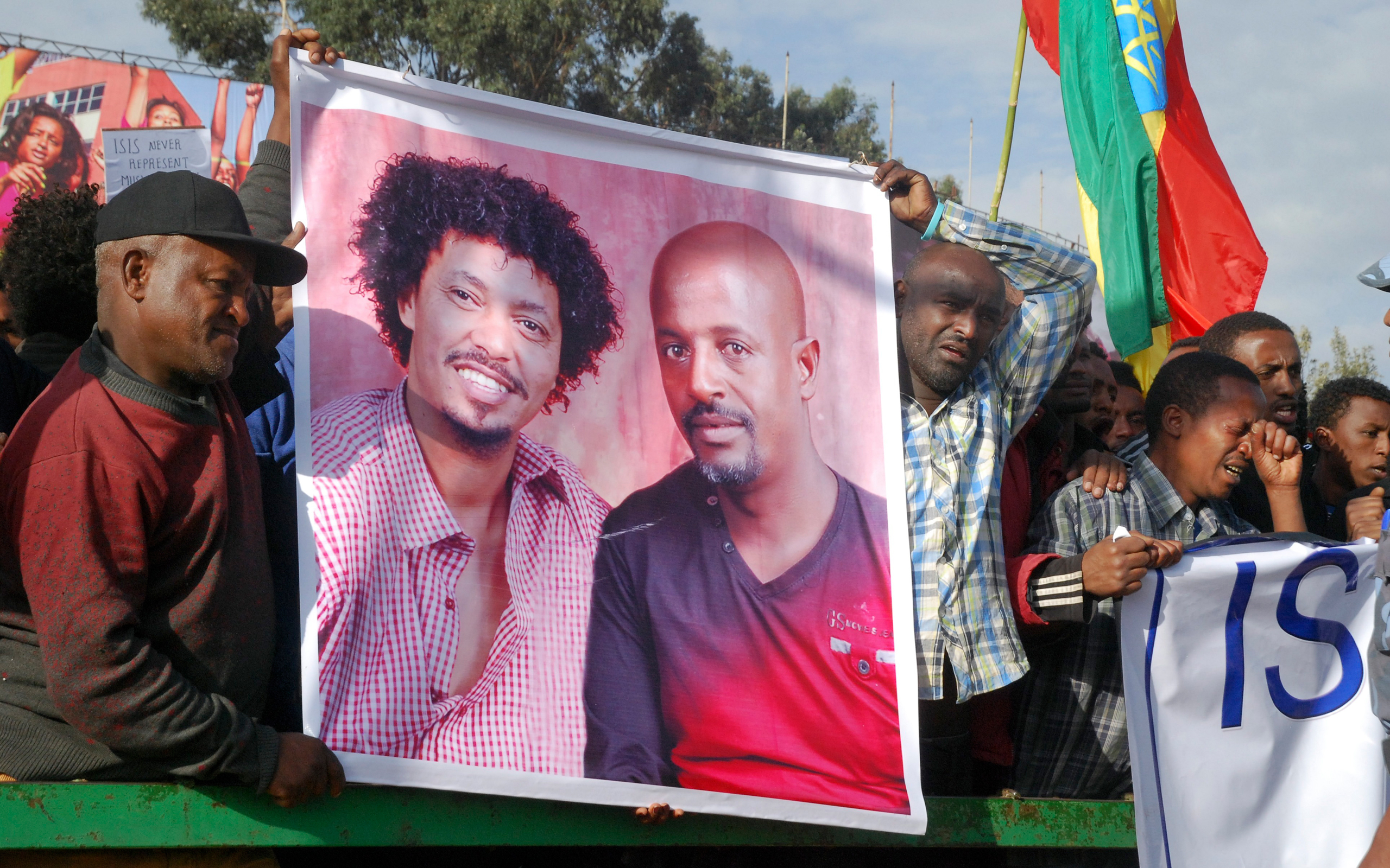 Protesters show a photo of Belete, right, and Yukuno-Amlak, on April 22 in Addis Ababa (AP)