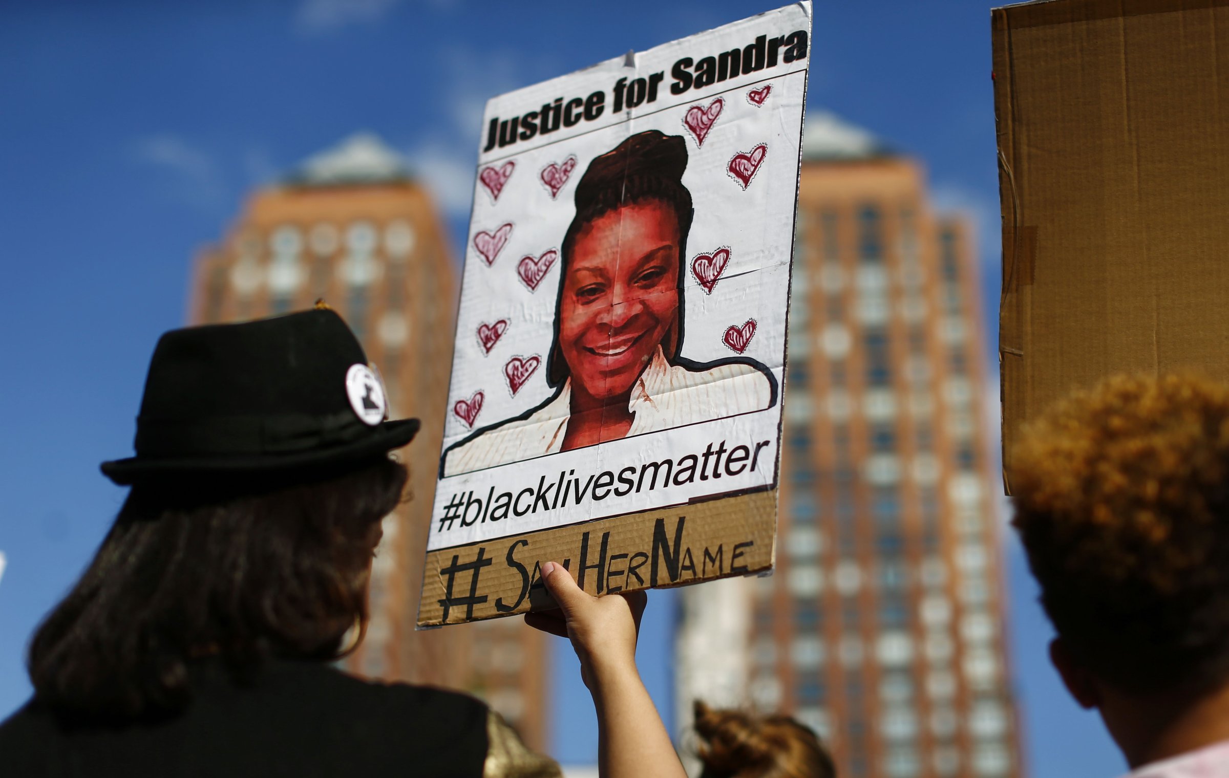 A woman holds a poster bearing the portrait of Sandra Bland, a 28-year-old black woman who killed herself in a Texas jail cell on July 13th, during a Michael Brown memorial rally in Union Square in New York on Aug. 9, 2015.