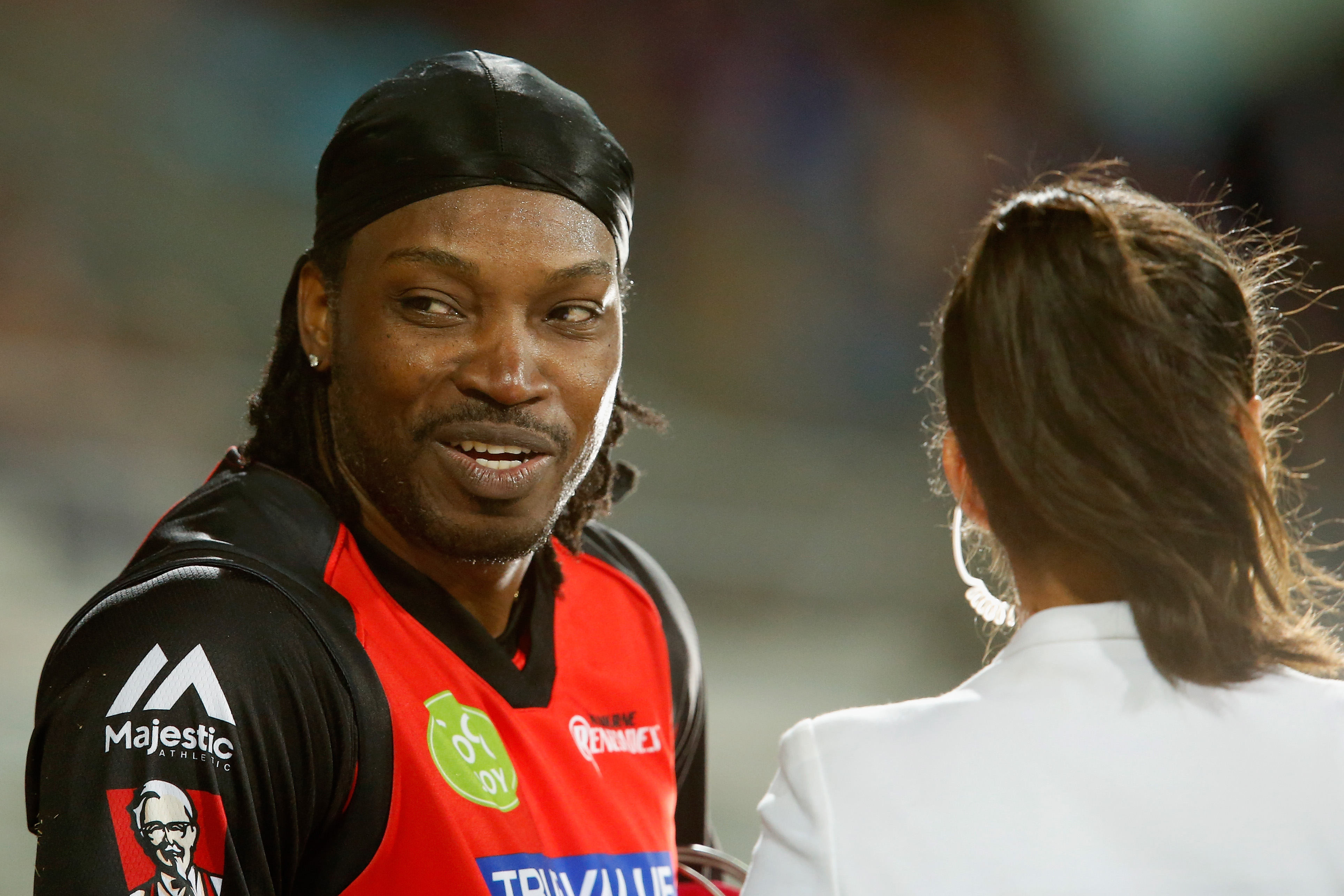 Chris Gayle of the Melbourne Renegades gives a TV interview to Mel Mclaughlin during the Big Bash League match between the Hobart Hurricanes and the Melbourne Renegades at Blundstone Arena in Hobart, Australia, on Jan. 4, 2016 (Darrian Traynor—Getty Images)