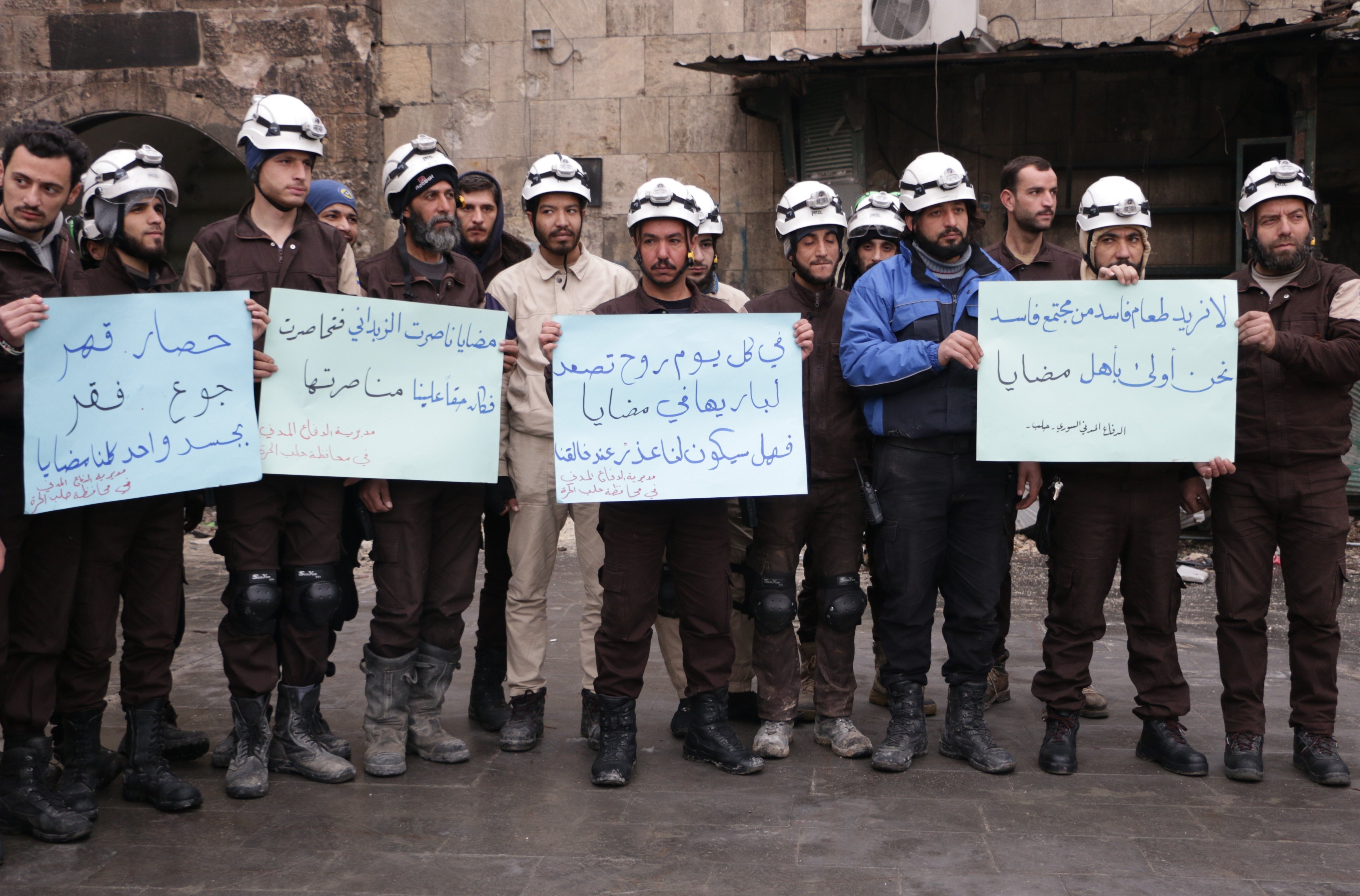Syrian civil defense team members protest for civilians who starved to death in Madaya, Jan. 6, 2016 in Aleppo, Syria (Anadolu Agency/Getty Images)