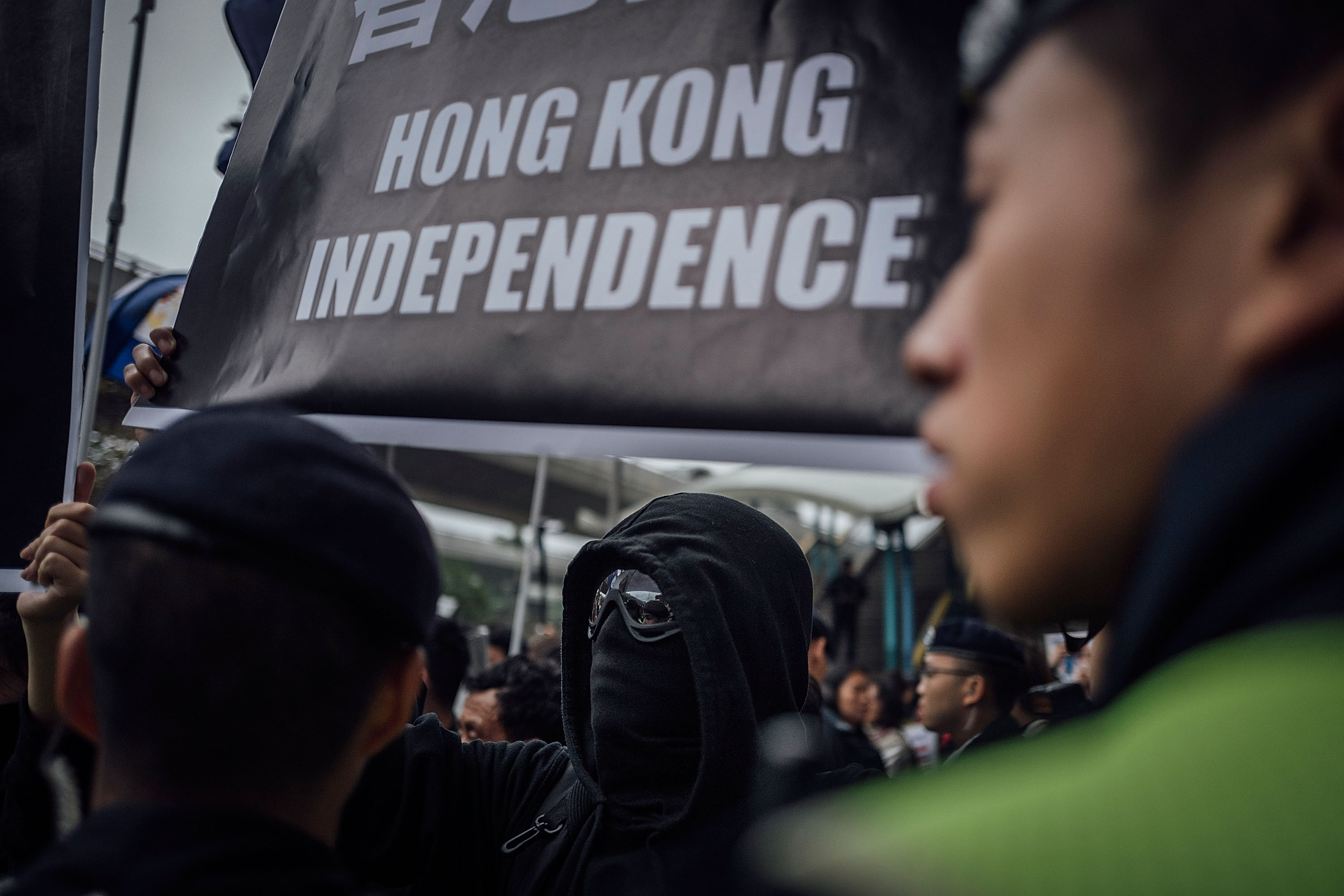 People hold placards and shout slogans as they take part in a rally on a street on Jan. 10, 2016, in Hong Kong over five missing booksellers (Anthony Kwan—Getty Images)