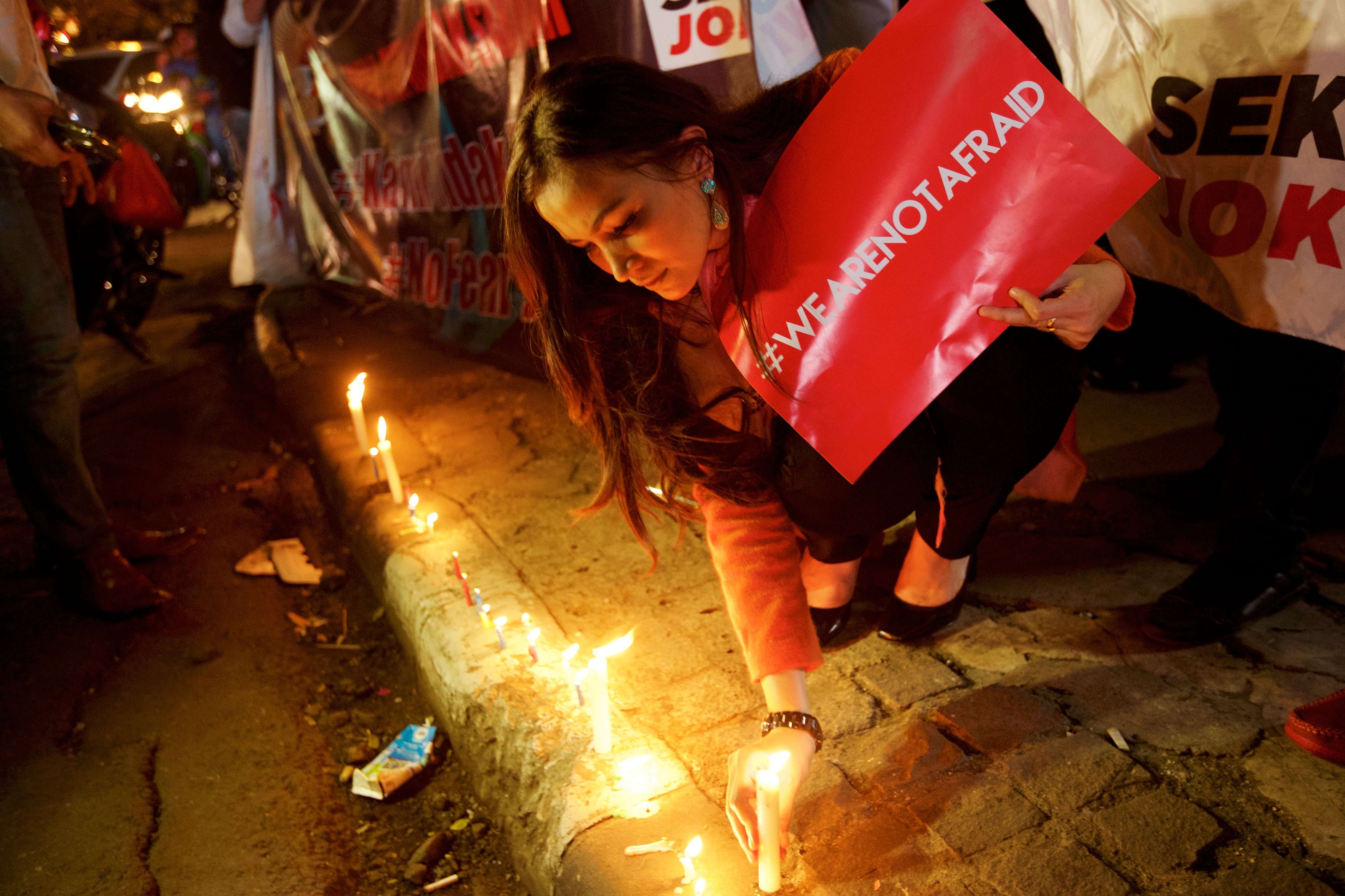 An Indonesian woman lights candles near the site of the terrorist attack during a "We Are Not Afraid" rally on Jan. 15, 2016, in Jakarta (Ed Wray—Getty Images)