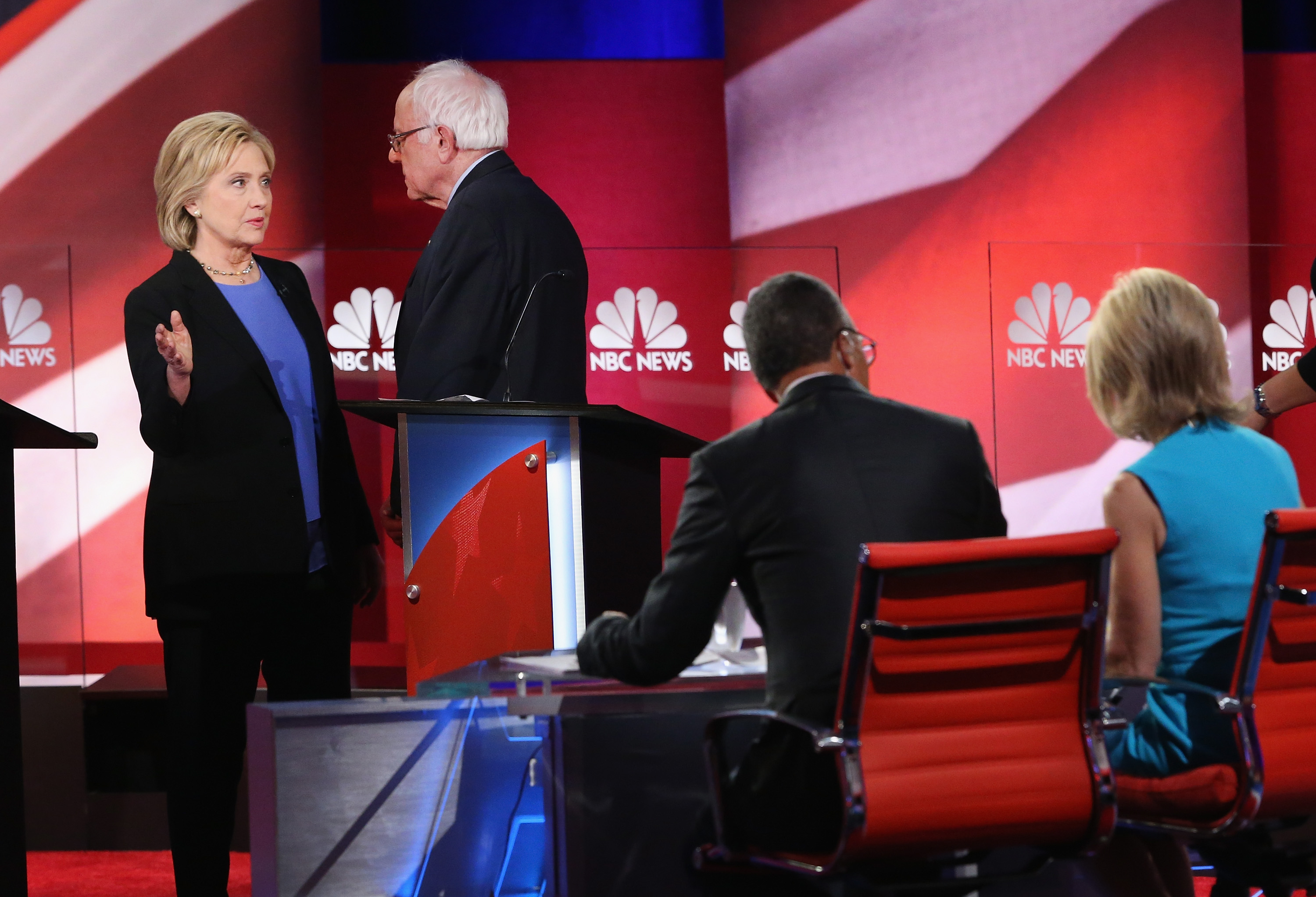 Democratic presidential candidates Hillary Clinton and Senator Bernie Sanders chat following the Democratic Candidates Debate hosted by NBC News and YouTube on Jan. 17, 2016 in Charleston, South Carolina. T (Andrew Burton—Getty Images)