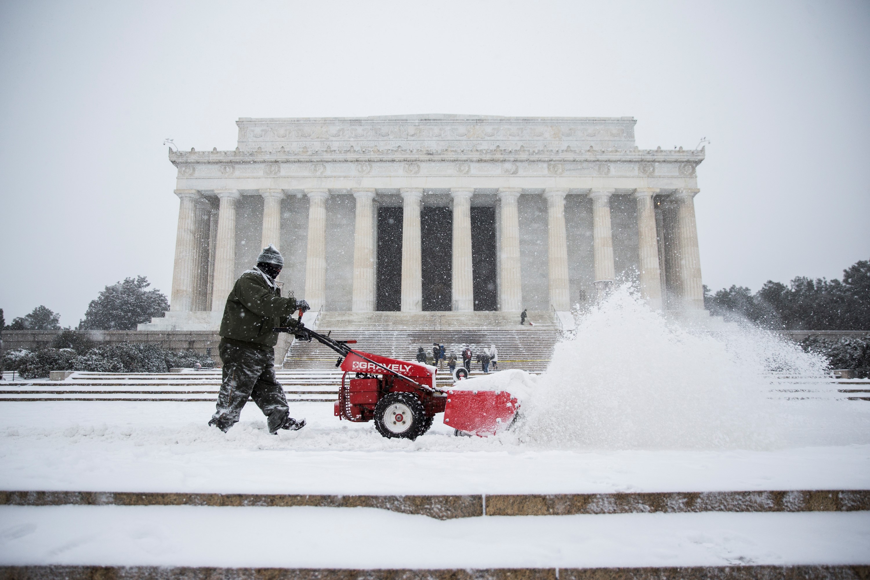 A worker clears snow from the steps of the Lincoln Memorial in Washington, DC on January 22, 2015.