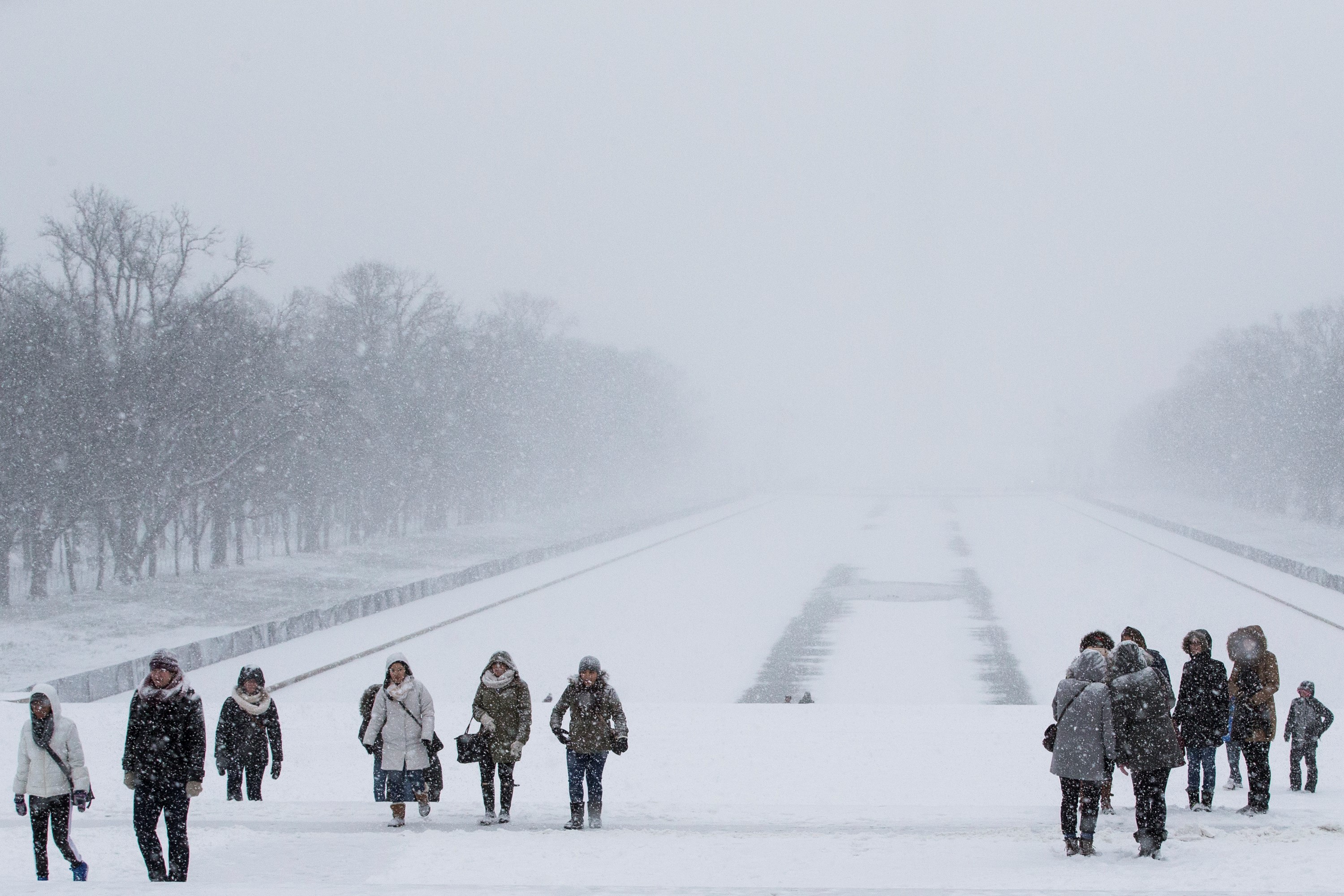 People walk along the steps between the Reflecting Pool and Lincoln Memorial in Washington, DC on Jan. 22, 2015.