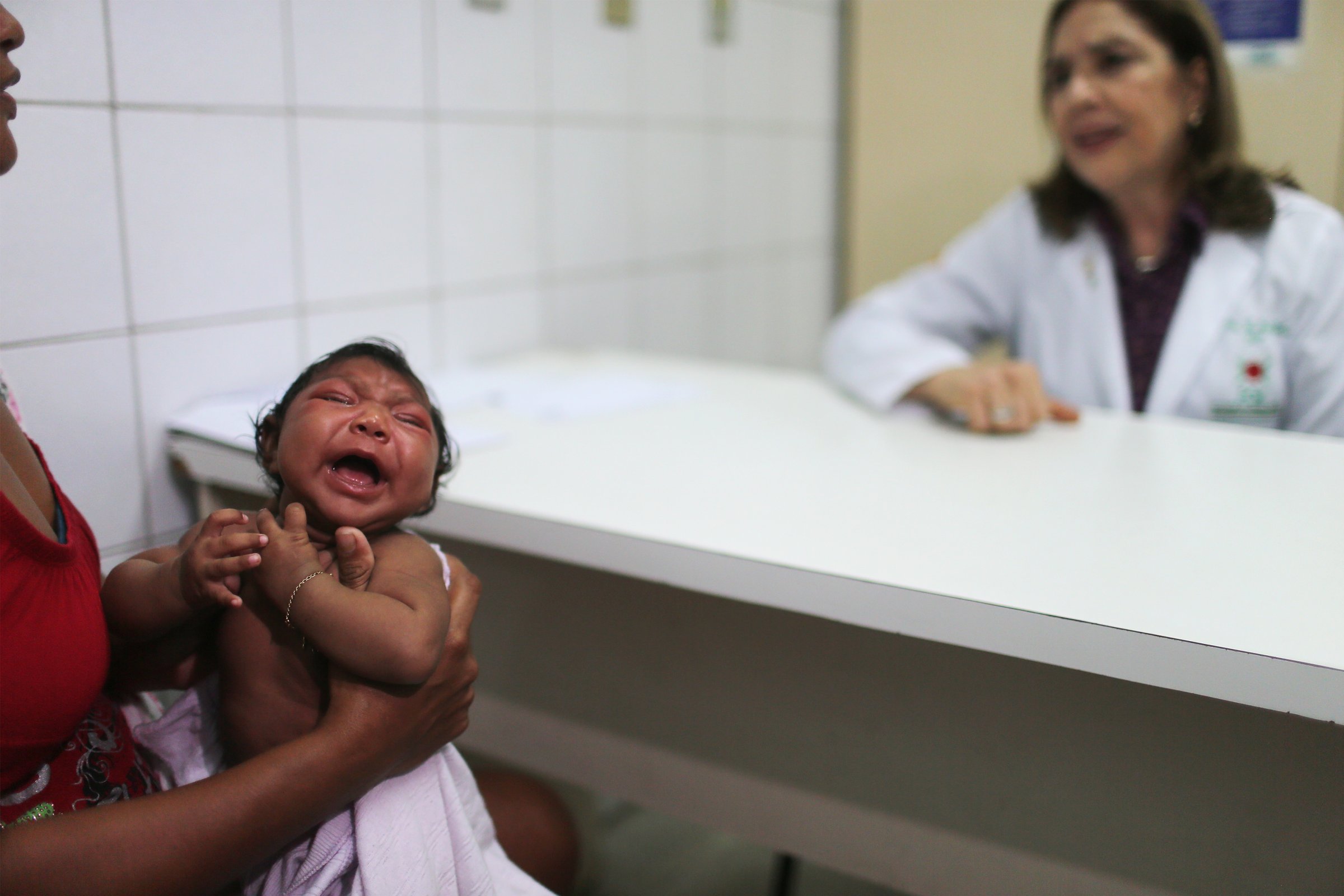 Dr. Angela Rocha (right), pediatric infectologist at Oswaldo Cruz Hospital, speaks during an examination of Ludmilla Hadassa Dias de Vasconcelos (2 months), who has microcephaly, in Recife, Brazil, on Jan. 26, 2016.