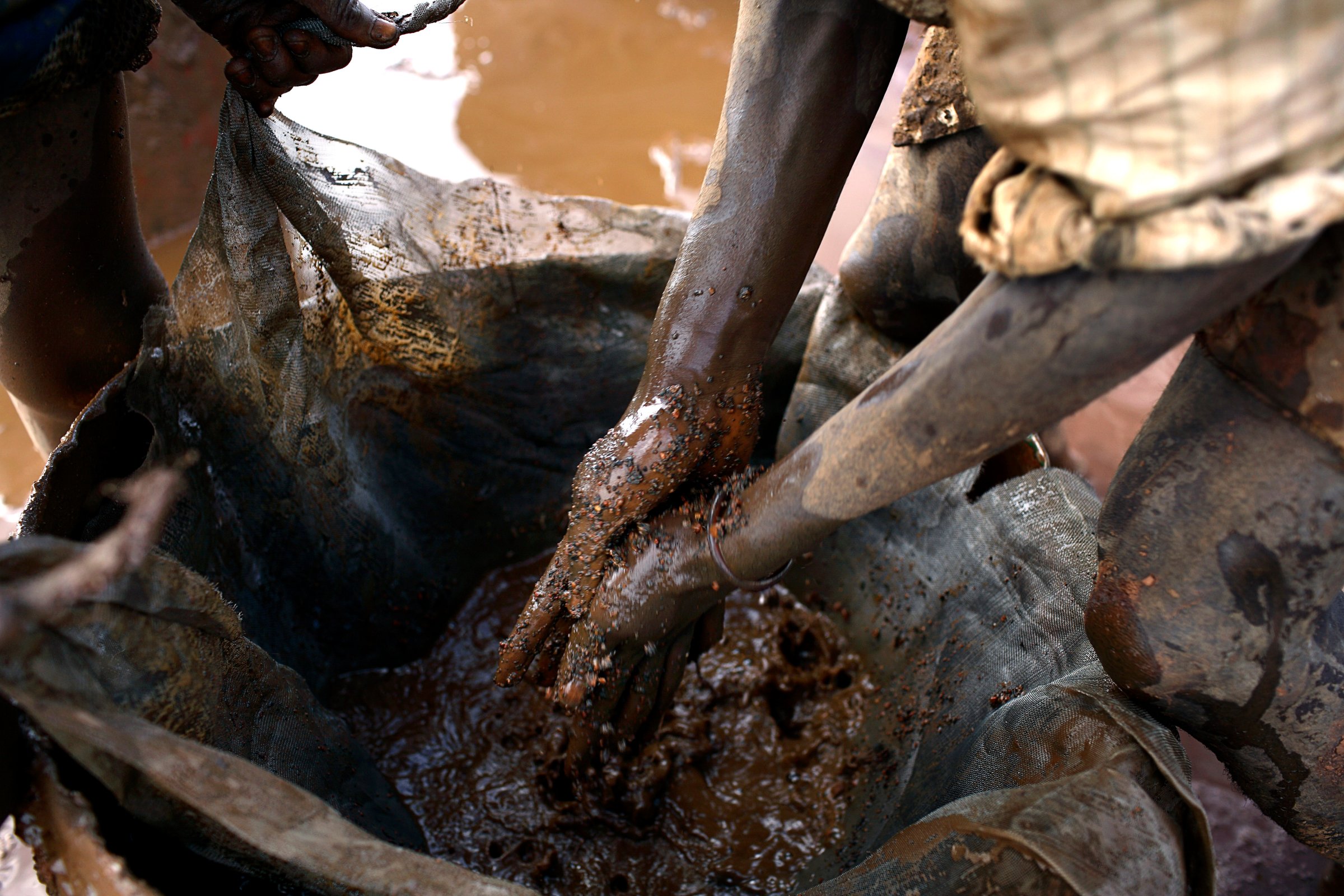 An unidentified young man cleans bags of cobalt from a cobalt mine in 2005 at Ruashi mine about 20 km outside Lubumbashi, the Democratic Republic of Congo.