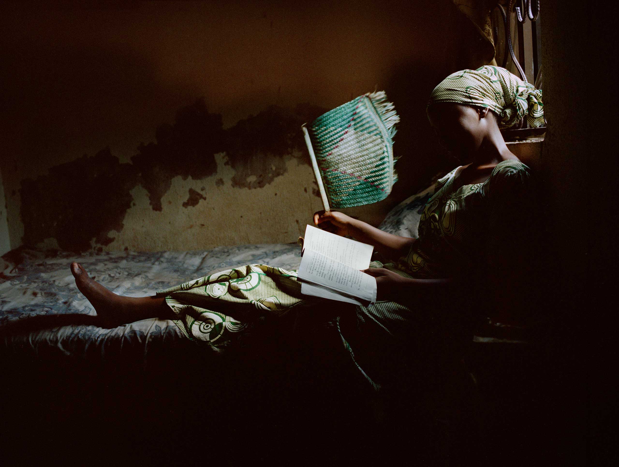 Firdausy El-yakub reads a romance novel in her bedroom in Kano, Northern Nigeria, March 21, 2013.