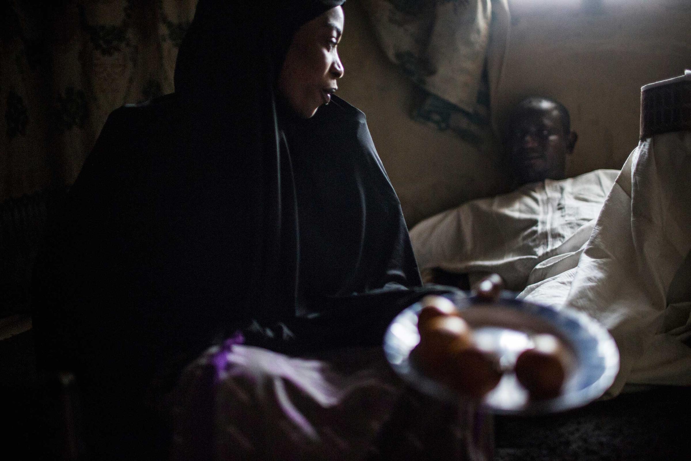 Rabi Tale, a romance novelist, sits at home with one of her suitors, Kano, Northern Nigeria, Feb. 23, 2014.