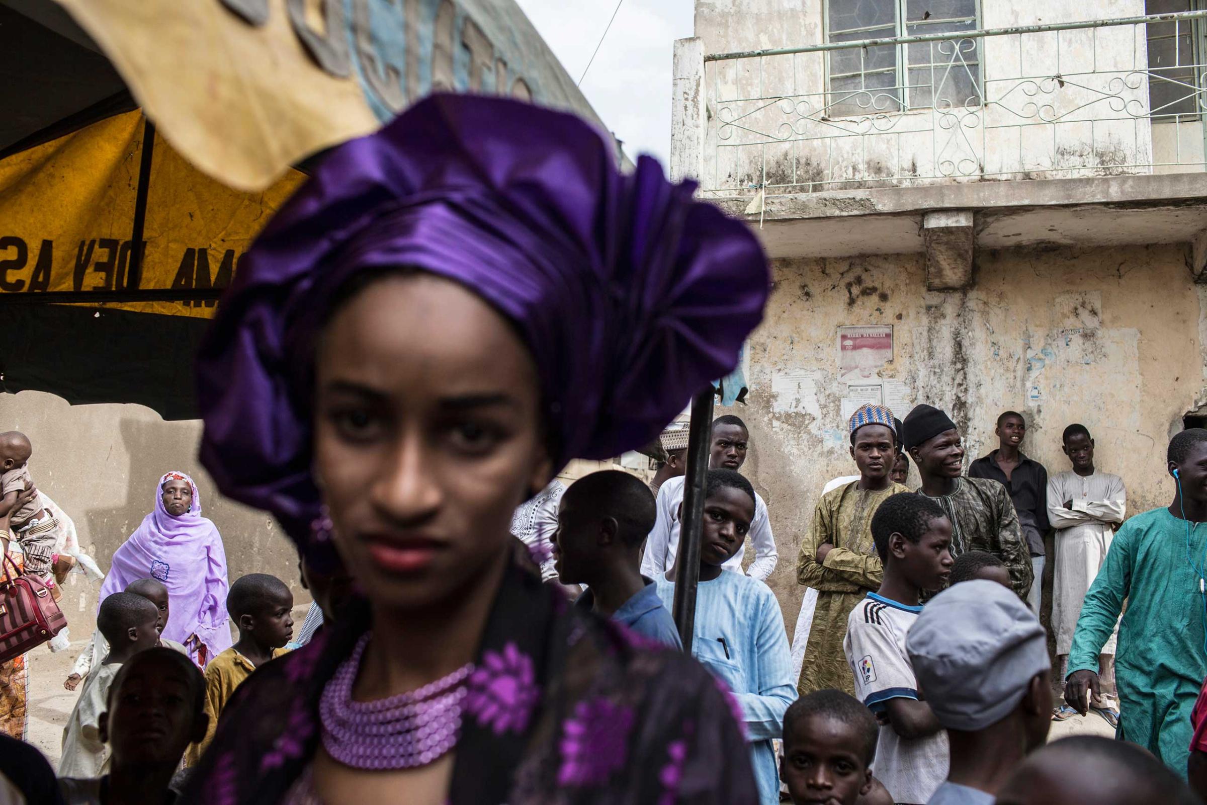A bride at a wedding stands apart from the guests, Kano, Northern Nigeria. April 7, 2013.