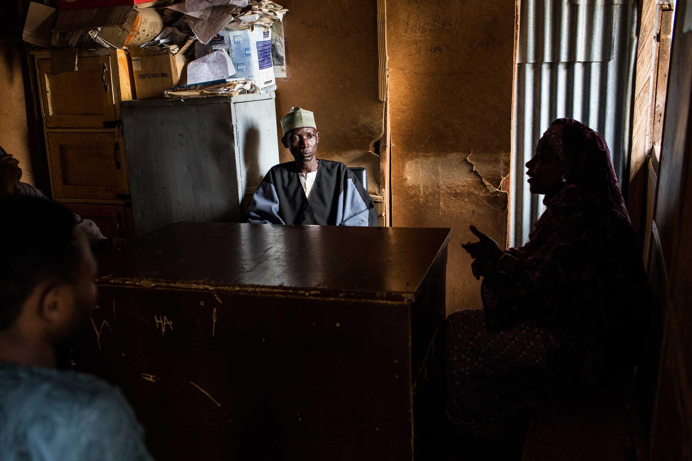 An officer of the Hisbah, adjudicates a family dispute in Kano, Northern Nigeria, Aug. 17, 2015.