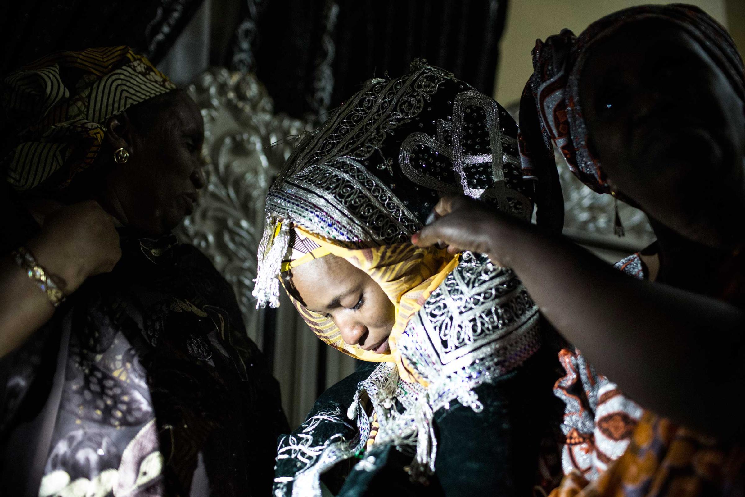 A bride is taken by her female relatives to her husband's home on the outskirts of Kano, Northern Nigeria, April 13, 2013.