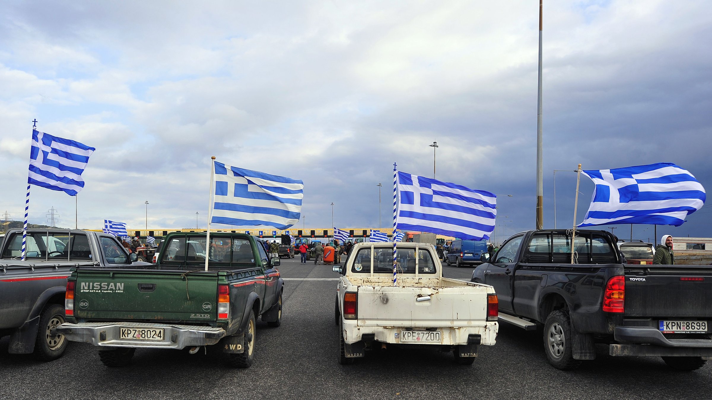 Greek farmers cut off the national road between Athens and Peloponnese at the toll posts near the city of Corinth on Jan. 23, 2016, to protest against the social security reforms planned by the government.