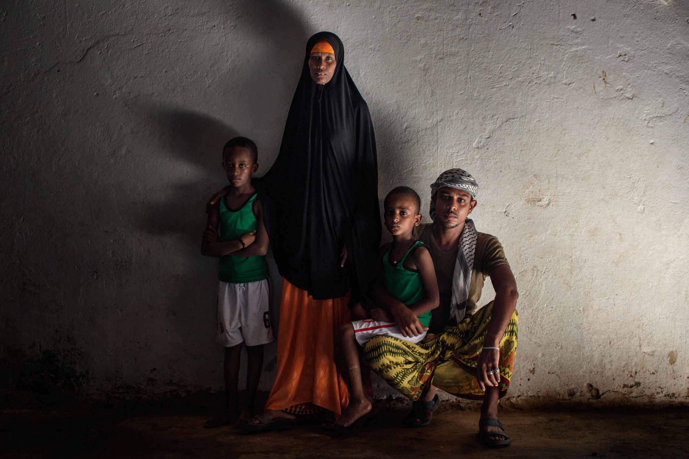 A. Abdalla Ali, a Yemeni refugee from Aden, Yemen, with his wife and their two sons. Abdalla was a house decorator back in his country. He left Yemen with his family when his neighborhood was bombed. Bosaso, Somalia,