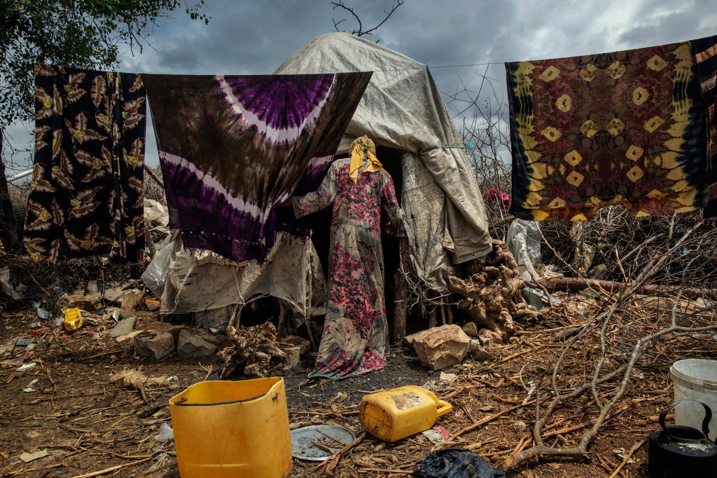 An internally displaced Somali woman walks inside a makeshift camp in Baidoa, in the Bay region, 150 miles from Mogadishu, Somalia. The internally displaced families fled to Baidoa town to escape famine in the surrounding areas. Baidoa, Somalia. October 14, 2015.