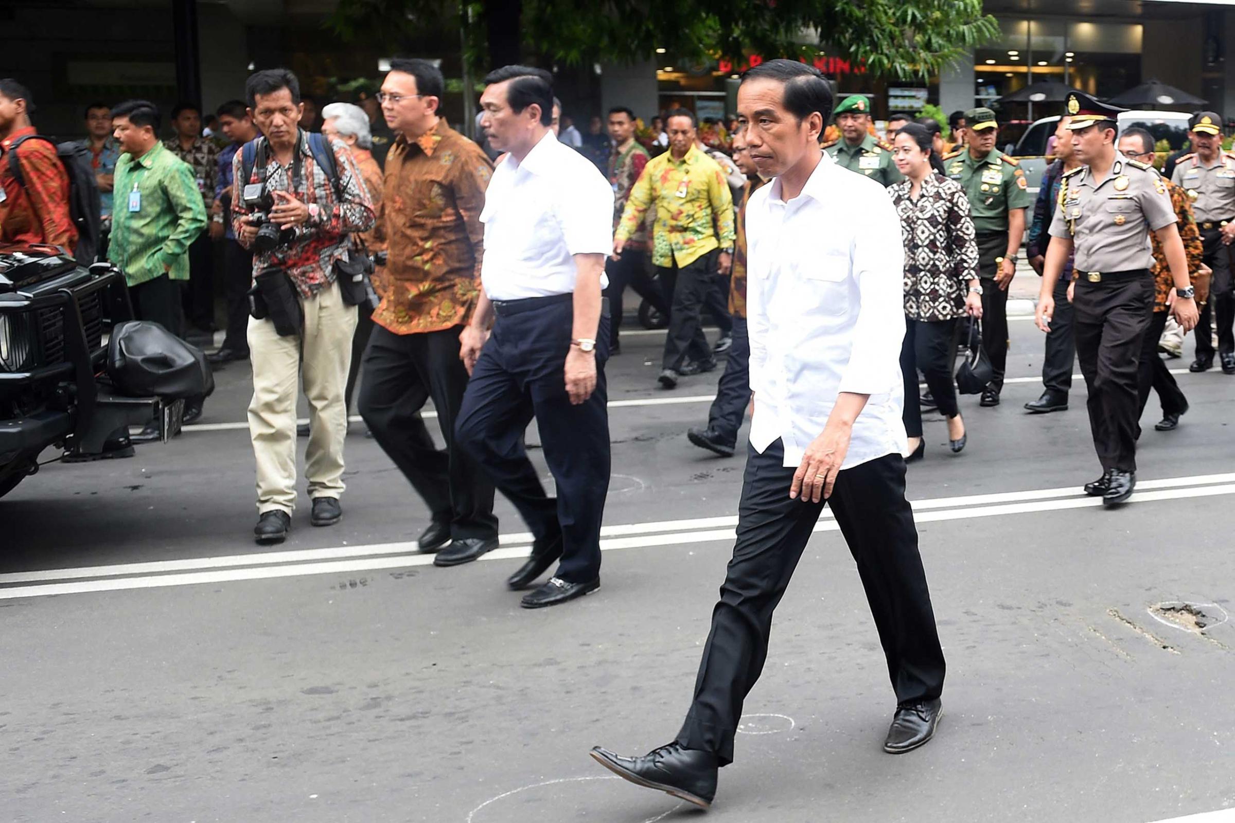 A handout picture provided by the Indonesian Presidential Palace shows President Joko Widodo visiting the blast site near a shopping mall in Jakarta, Indonesia, Jan. 14, 2016. At least seven people, including five suspected assailants, died in bomb blasts and gunfire in the attack.