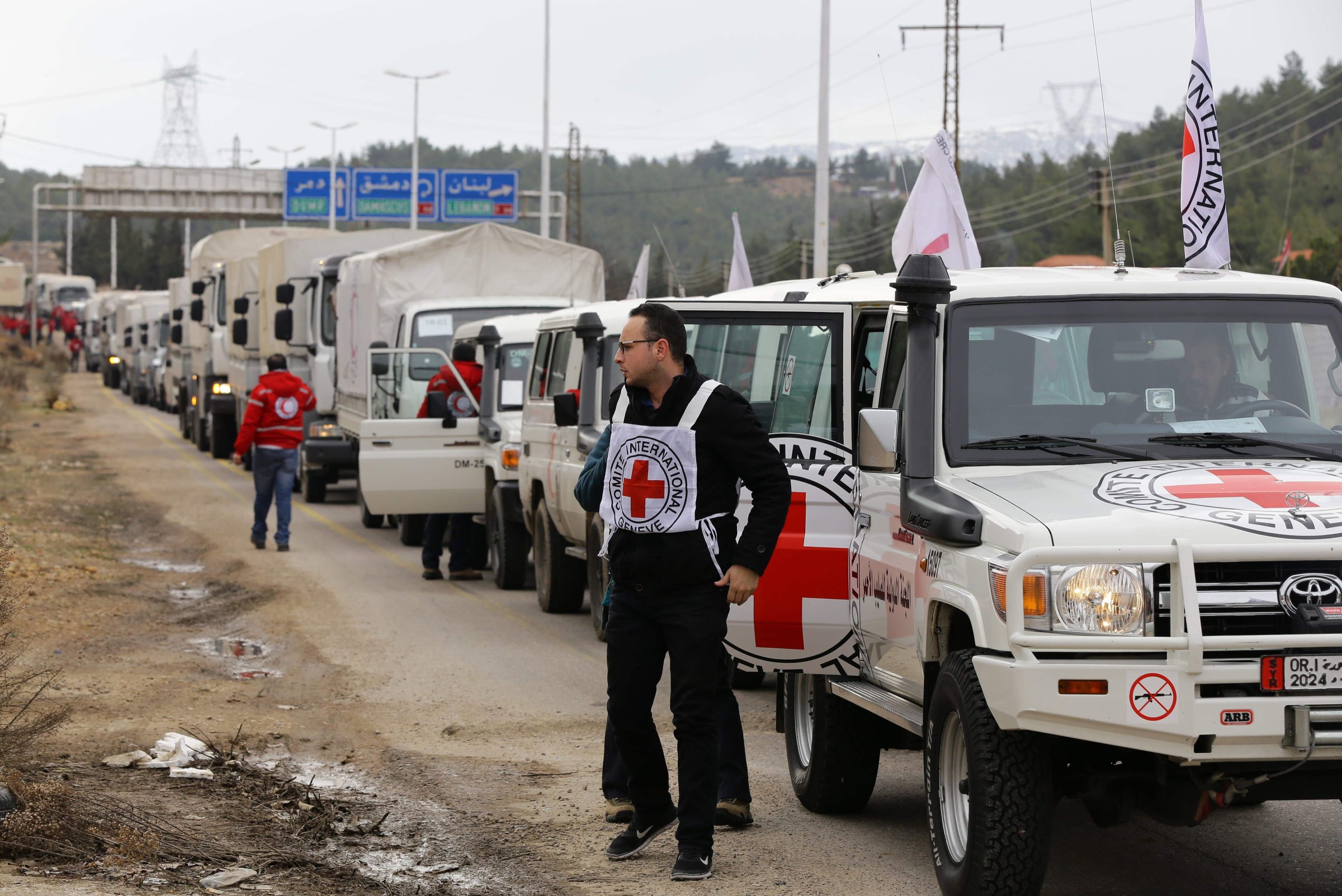A convoy of aid from the International Committee of the Red Cross (ICRC) waits on the outskirts of the besieged rebel-held Syrian town of Madaya, on Jan. 11, 2016.
