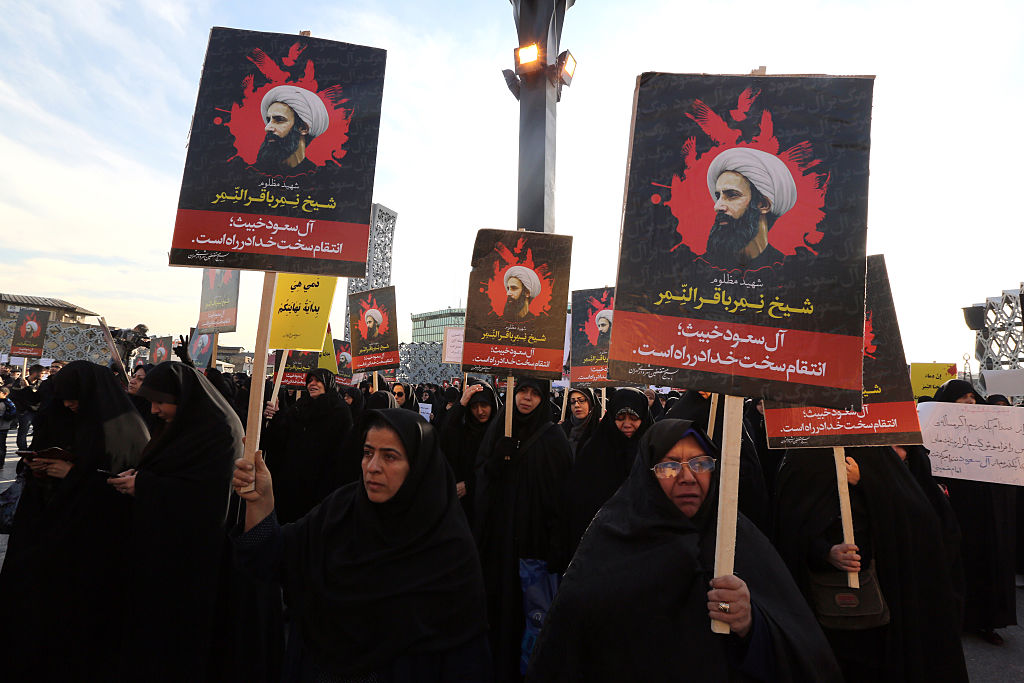 Iranian women gather during a demonstration against the execution of prominent Shiite Muslim cleric Nimr al-Nimr (portrait) by Saudi authorities, at Imam Hossein Square in the capital Tehran on Jan. 4, 2016.