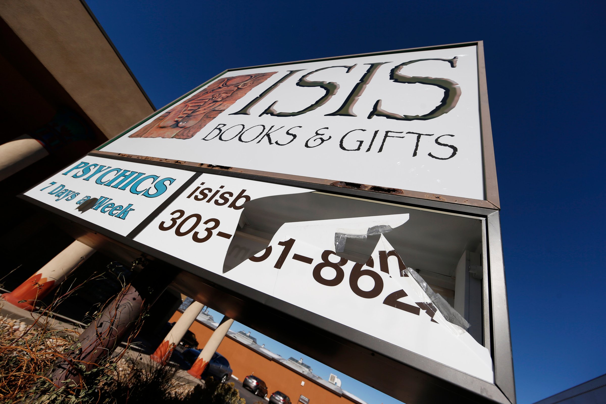 A panel of the sign outside Isis Books and Gifts is shown broken on Nov. 18, 2015, in Englewood, Colo.