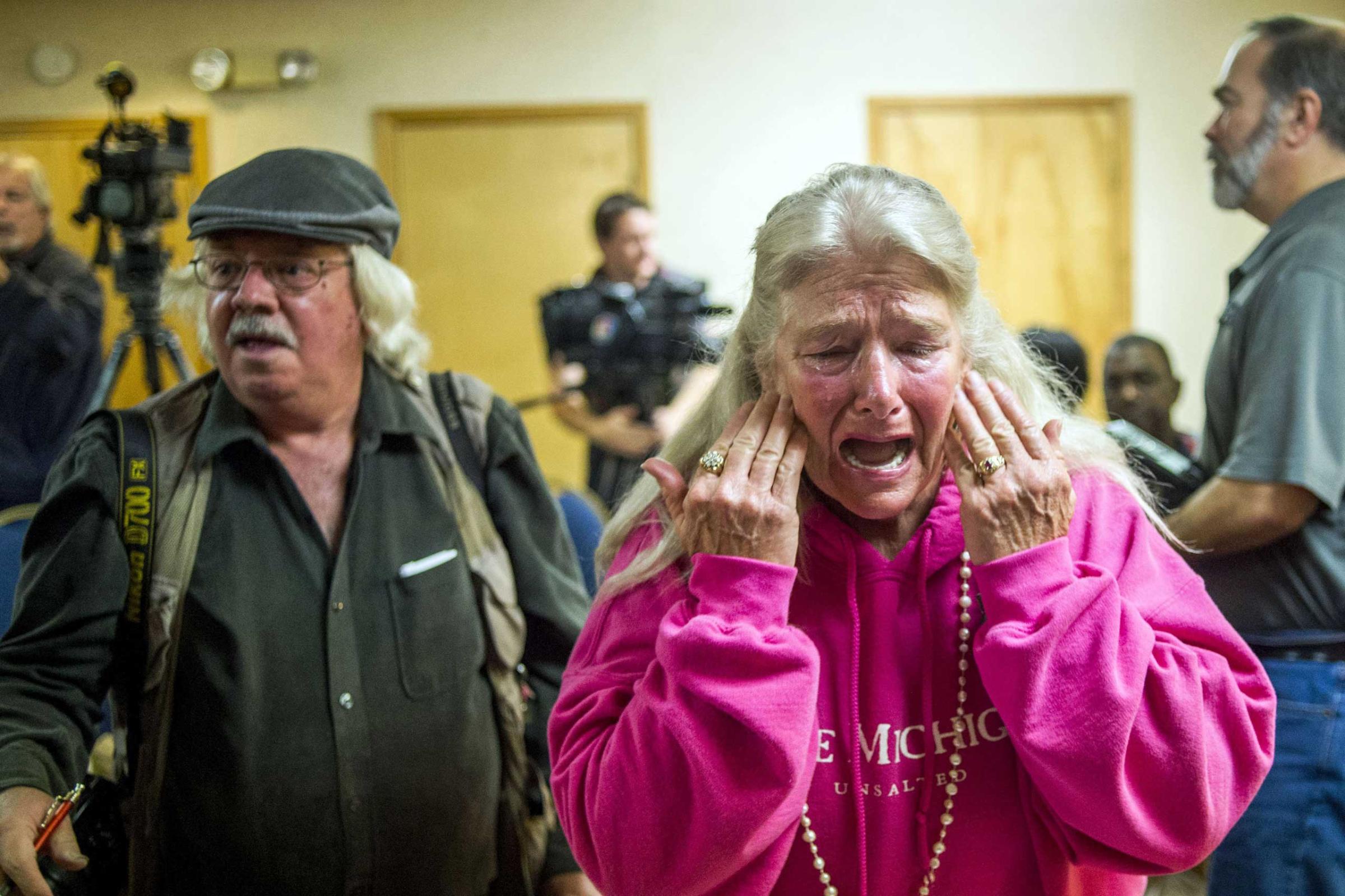Flint resident Gladyes Williamson cries out through her tears to Melissa Mays, one of six plaintiffs, overwhelmed with frustration of the water issue and joy in the filing of a potential class action lawsuit against both city and state government officials on Nov. 16, 2015, at the Holiday Inn Express in Flint, Mich. The lawsuit claims that these government officials violated constitutional rights providing lead-tainted water to residents, which lead to alleged developing health issues, including hair loss, depression and auto-immune disorders.