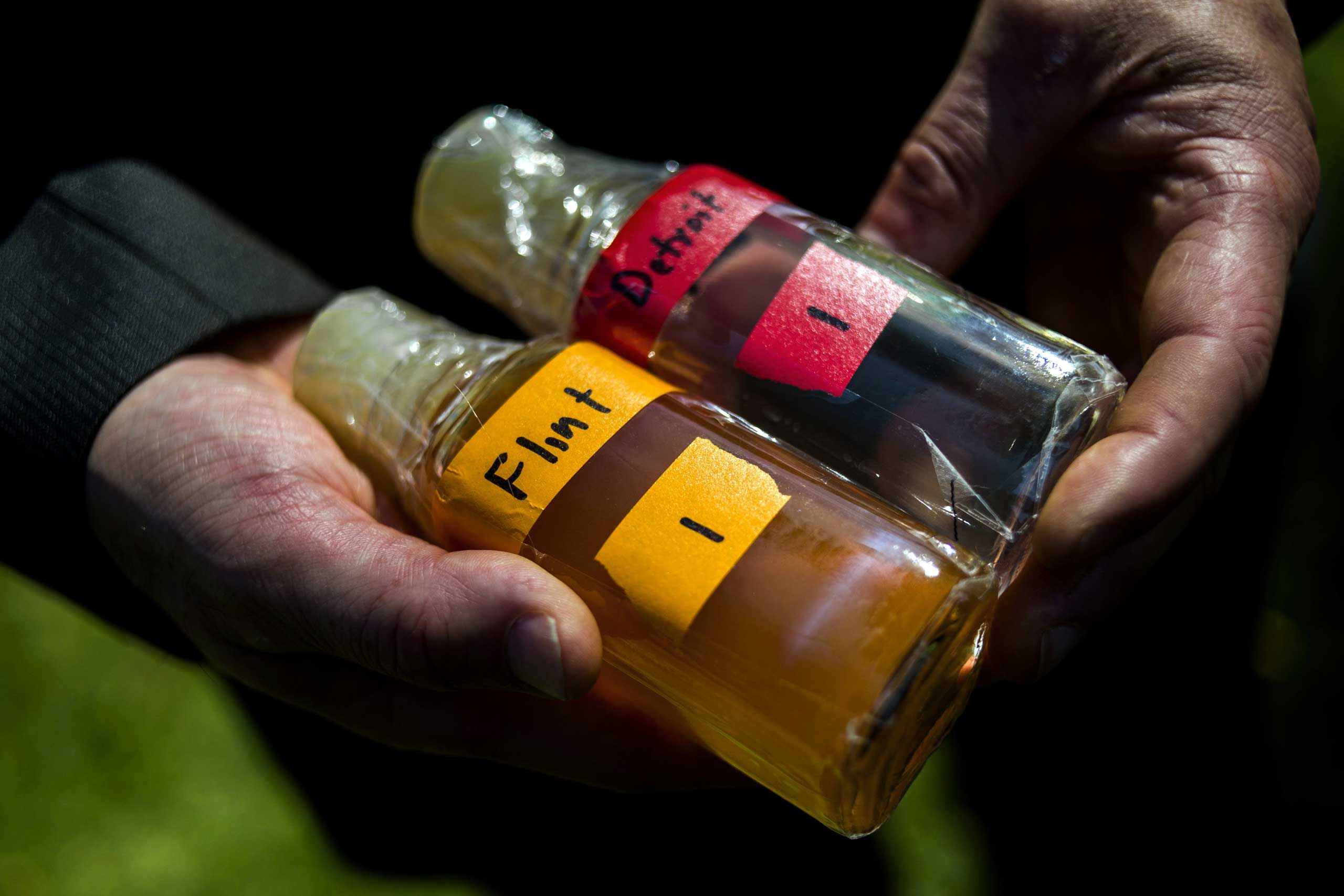 Virginia Tech professor Marc Edwards shows the difference in water quality between Detroit and Flint after testing, giving evidence after more than 270 samples were sent in from Flint that show high levels of lead during a news conference on Sept. 15, 2015 outside of City Hall in downtown Flint, Mich.