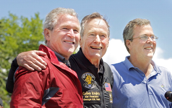 Former President George H. W. Bush poses with his sons former President George W. Bush and Jeb Bush. (Portland Press Herald—Getty Images)