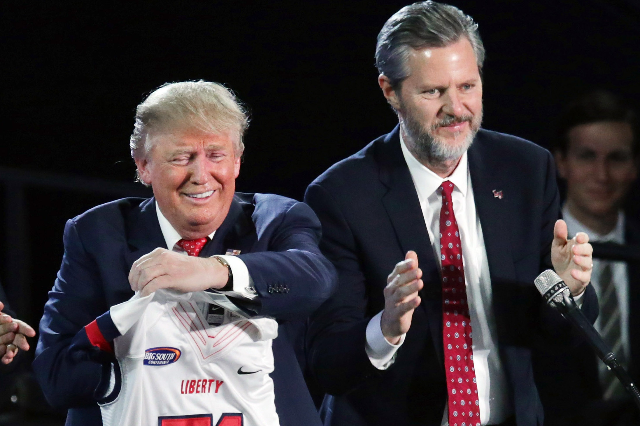 Jerry Falwell, Jr. presents Republican presidential candidate Donald Trump with a sports jersey after he delivered the convocation on Jan. 18, 2016 in Lynchburg, Va. (Chip Somodevilla—Getty Images)