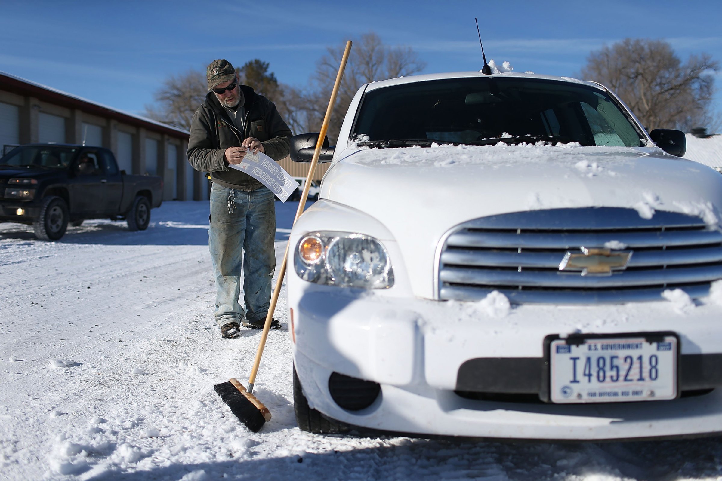 BURNS, OR - JANUARY 15: Ken Medenbach prepares to paste a Harney County sticker on the side of a U.S. Government vehicle as a group continues to occupy the Malheur National Wildlife Refuge headquarters on January 15, 2016 near Burns, Oregon. The armed anti-government militia group continues to occupy the Malheur National Wildlife Headquarters as they protest the jailing of two ranchers for arson. (Photo by Joe Raedle/Getty Images)