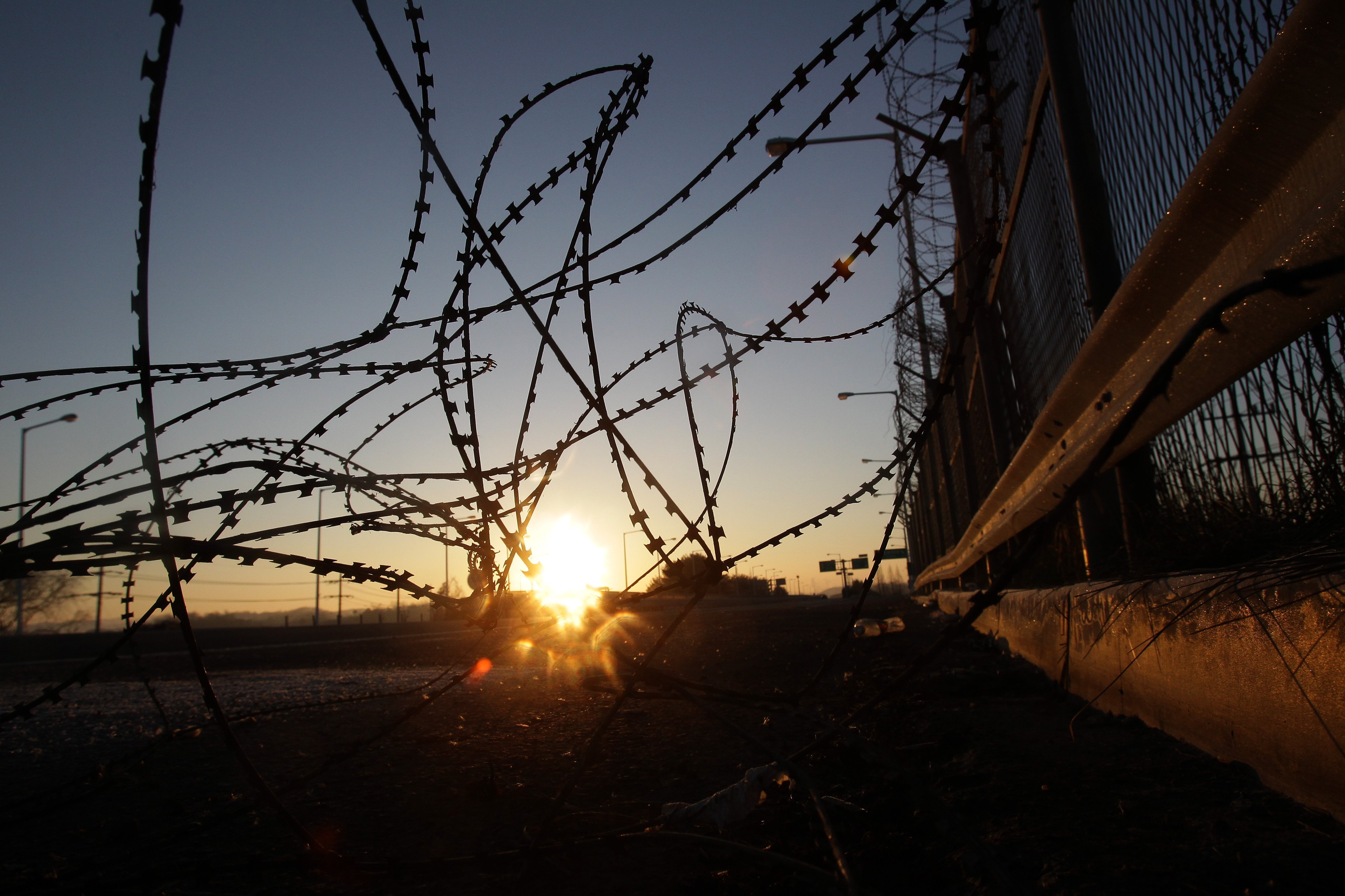 A sunrise is seen through a barbed-wire fence at the Imjingak, near the Demilitarized zone separating South and North Korea in Paju, South Korea, on Jan. 8, 2016. (Chung Sung-Jun—Getty Images)