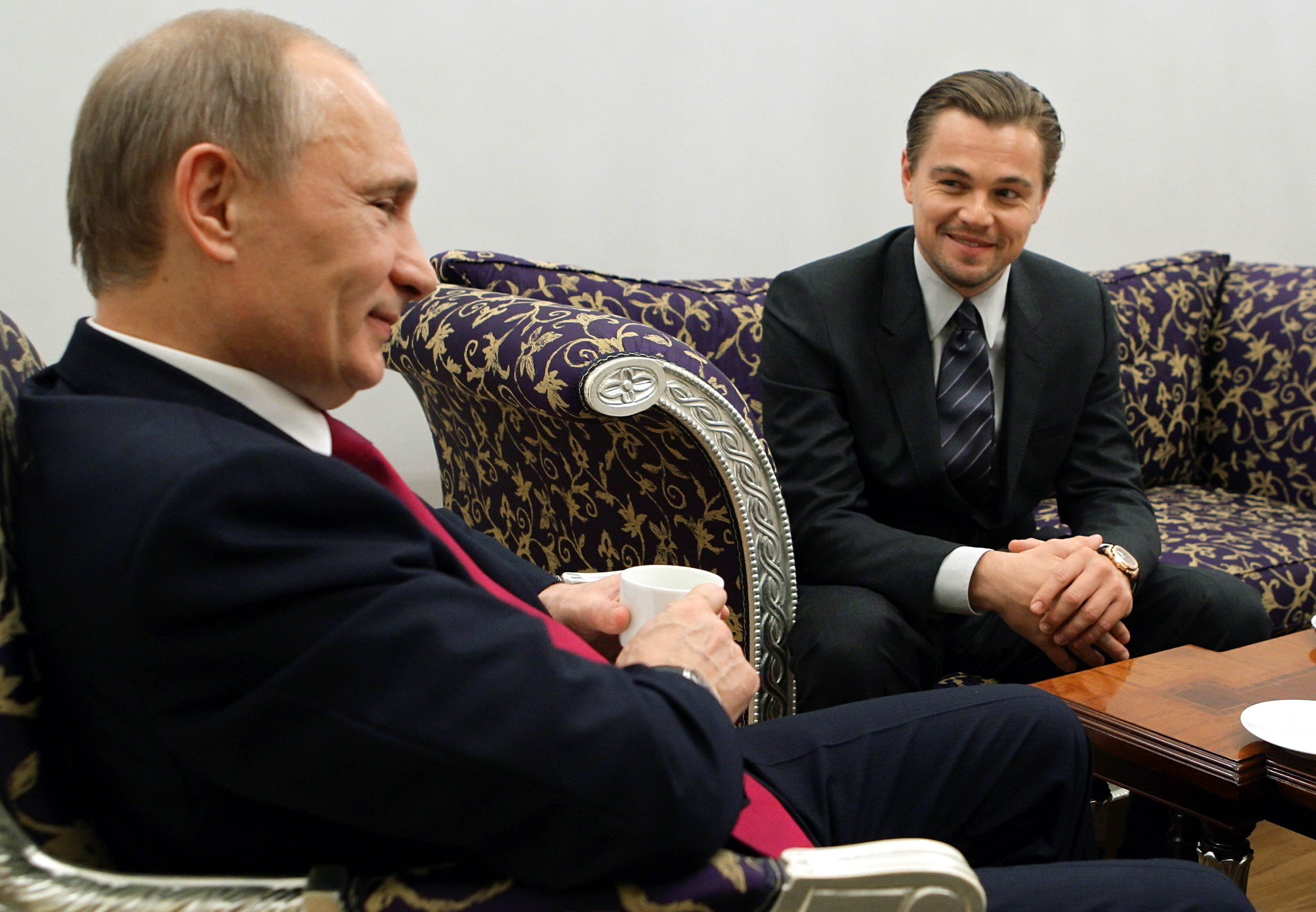 Russia's Prime Minister Vladimir Putin (L) speaks with Leonardo DiCaprio after a concert to mark the International Tiger Conservation Forum at the Mikhailovsky theater in Saint Petersburg on Nov. 23, 2010.