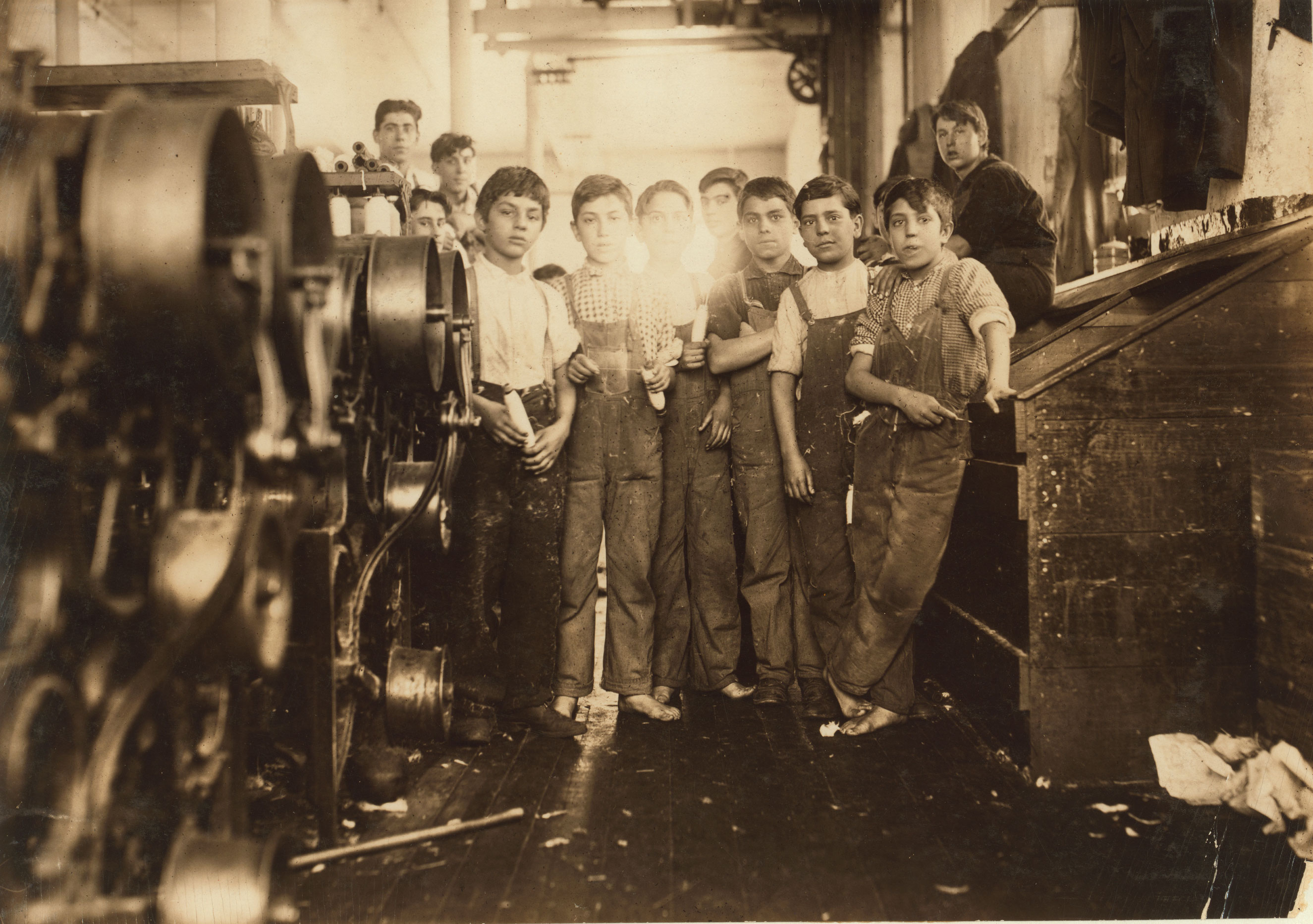 Young doffer and spinner boys in Seaconnet Mill. The youngest are Manuel Perry, 111 Pitman St. John E. Mello, 229 Alden St. Manuel Louis. None of these could write their own names. The last couldn't spell the street he lives on. They spoke almost no English. Jan. 1912. Fall River, Massachusetts.