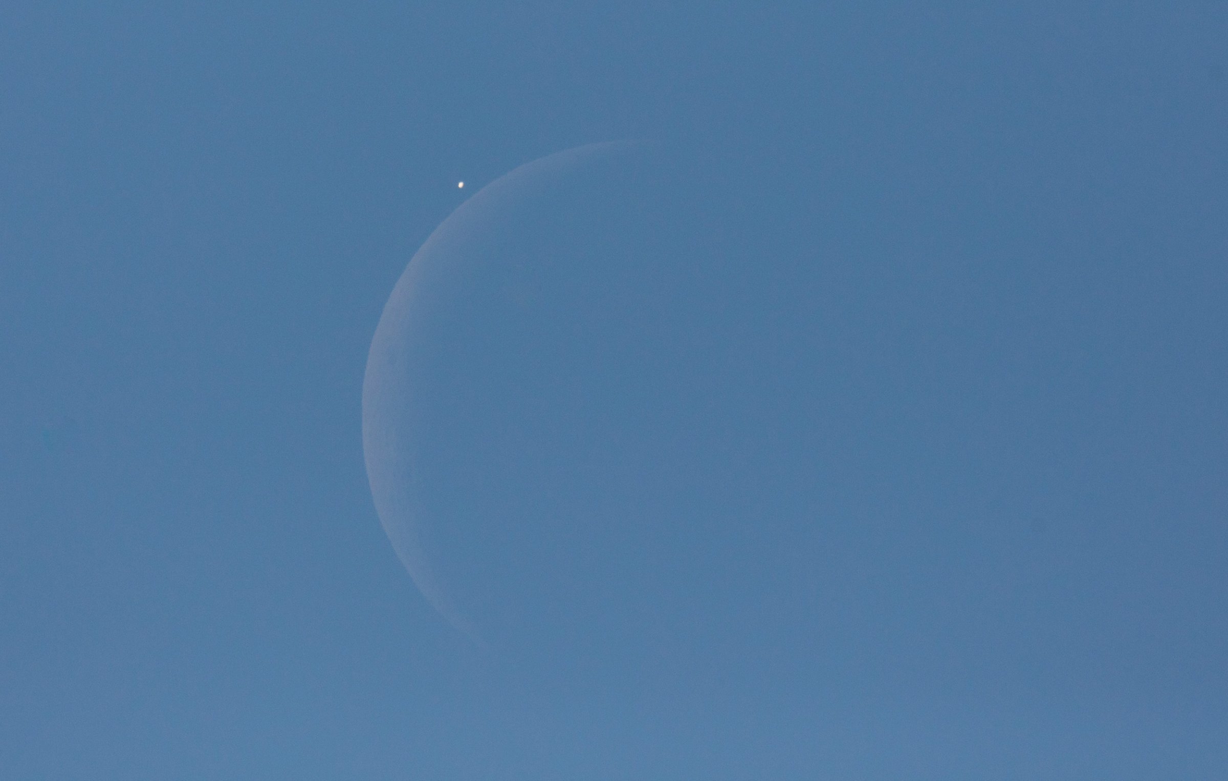 Venus is seen next to the crescent moon during the daytime, prior to the start of occultation in Washington, D.C. on Dec. 7, 2015. The moon had occulted, or passed in front of, Venus for the second time that year.