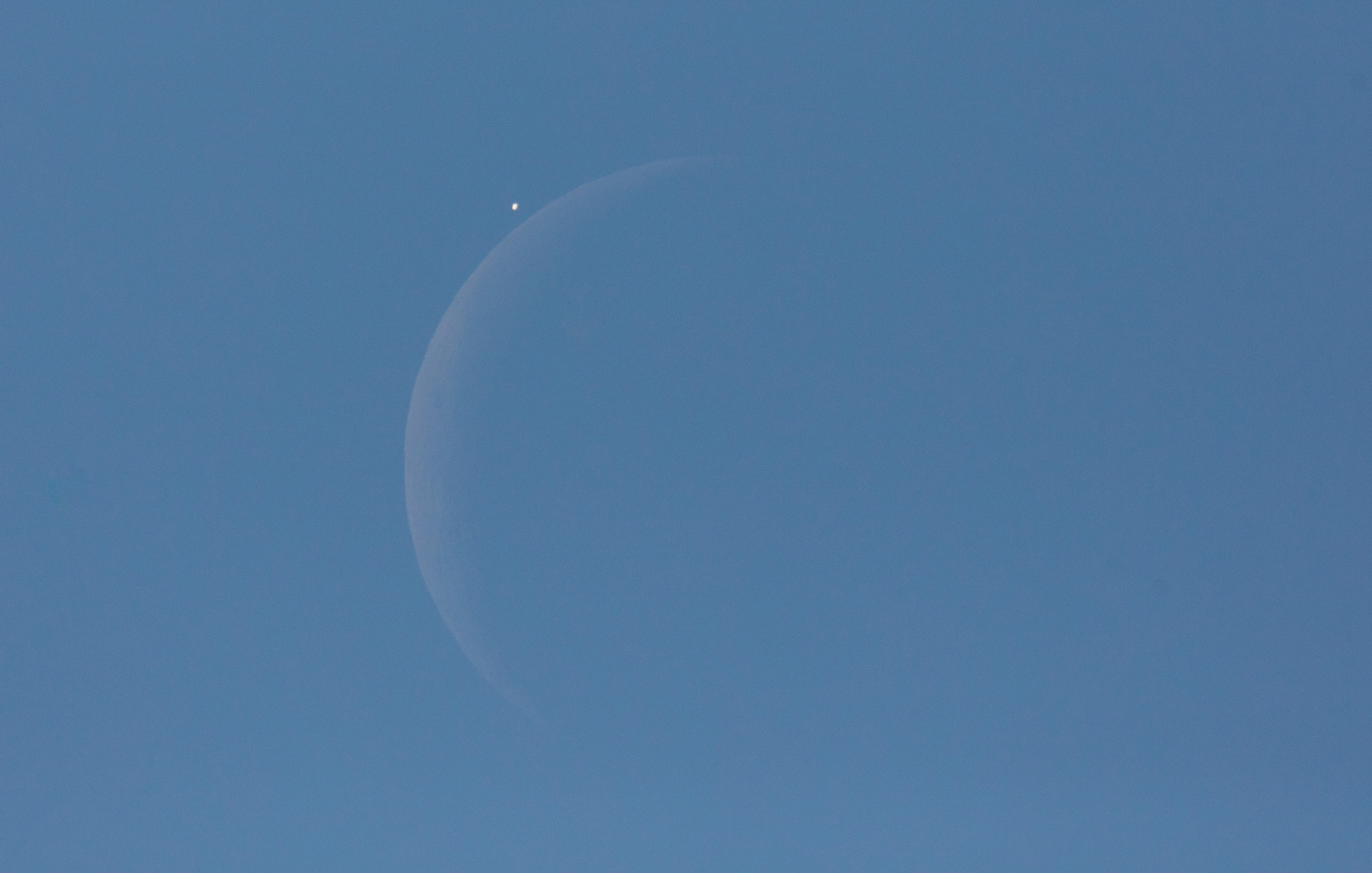 Venus is seen next to the crescent moon during the daytime, prior to the start of occultation in Washington, D.C. on Dec. 7, 2015.  The moon had occulted, or passed in front of, Venus for the second time that year. (Joel Kowsky—NASA)