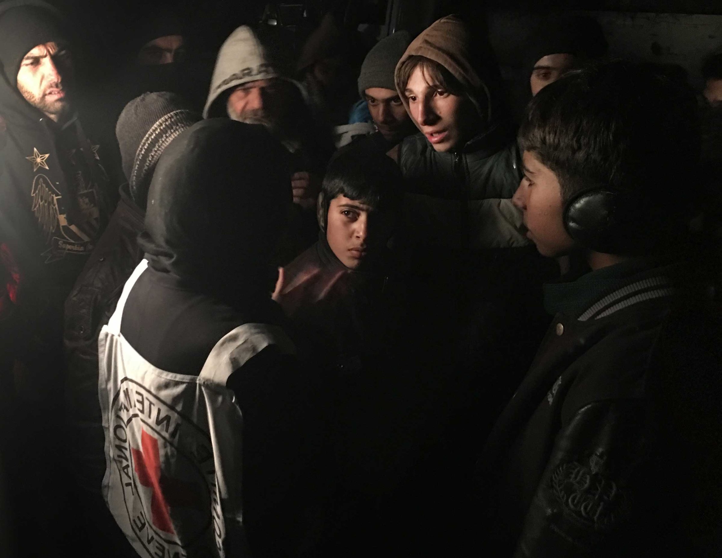 ICRC Head of Delegation Marianne Gasser speaks to residents of Madaya, a besieged town in Syria, as they gather around an aid convoy, Jan. 11, 2016. The International Committee of the Red Cross, working alongside the Syrian Arab Red Crescent and United Nations, began to deliver aid to thousands of people living in three besieged areas in Syria.