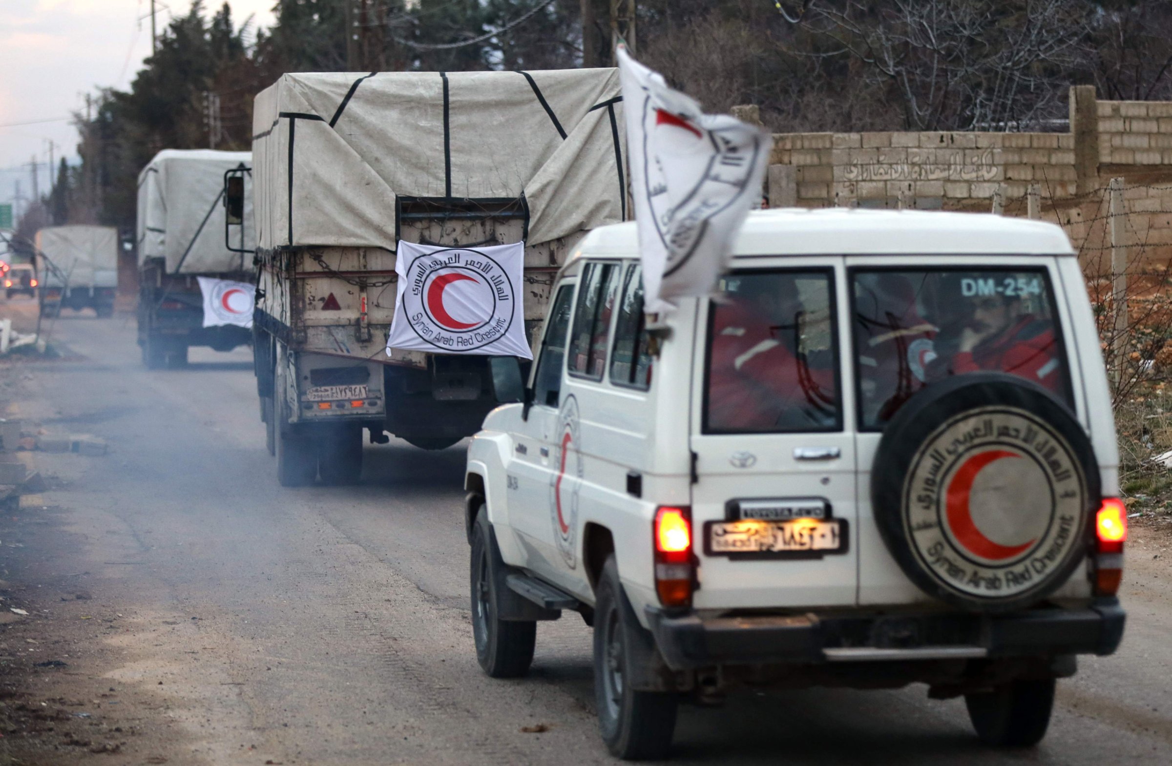 Vehicles from the Syrian Arab Red Crescent drive in a convoy on the outskirts of the besieged rebel-held Syrian town of Madaya, on Jan. 11, 2016. Dozens of aid trucks headed to Madaya, where more than two dozen people are reported to have starved to death, after an outpouring of international concern and condemnation over the dire conditions in the town, where some 42,000 people are living under a government siege. / AFP / LOUAI BESHARALOUAI BESHARA/AFP/Getty Images