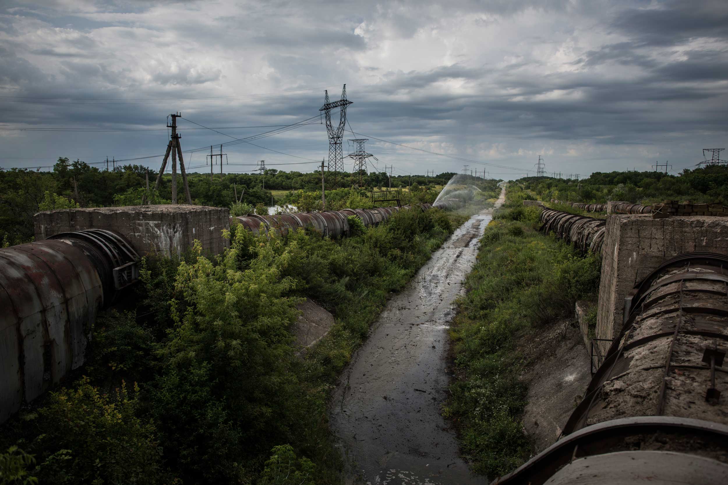 A damaged water pipeline that distributes water for the Donetsk region runs at the frontline between positions of Donetsk peoples republic and Ukrainian forces near Horlivka and Dzerzhinsk, Donetsk region, eastern Ukraine, July 5, 2015.