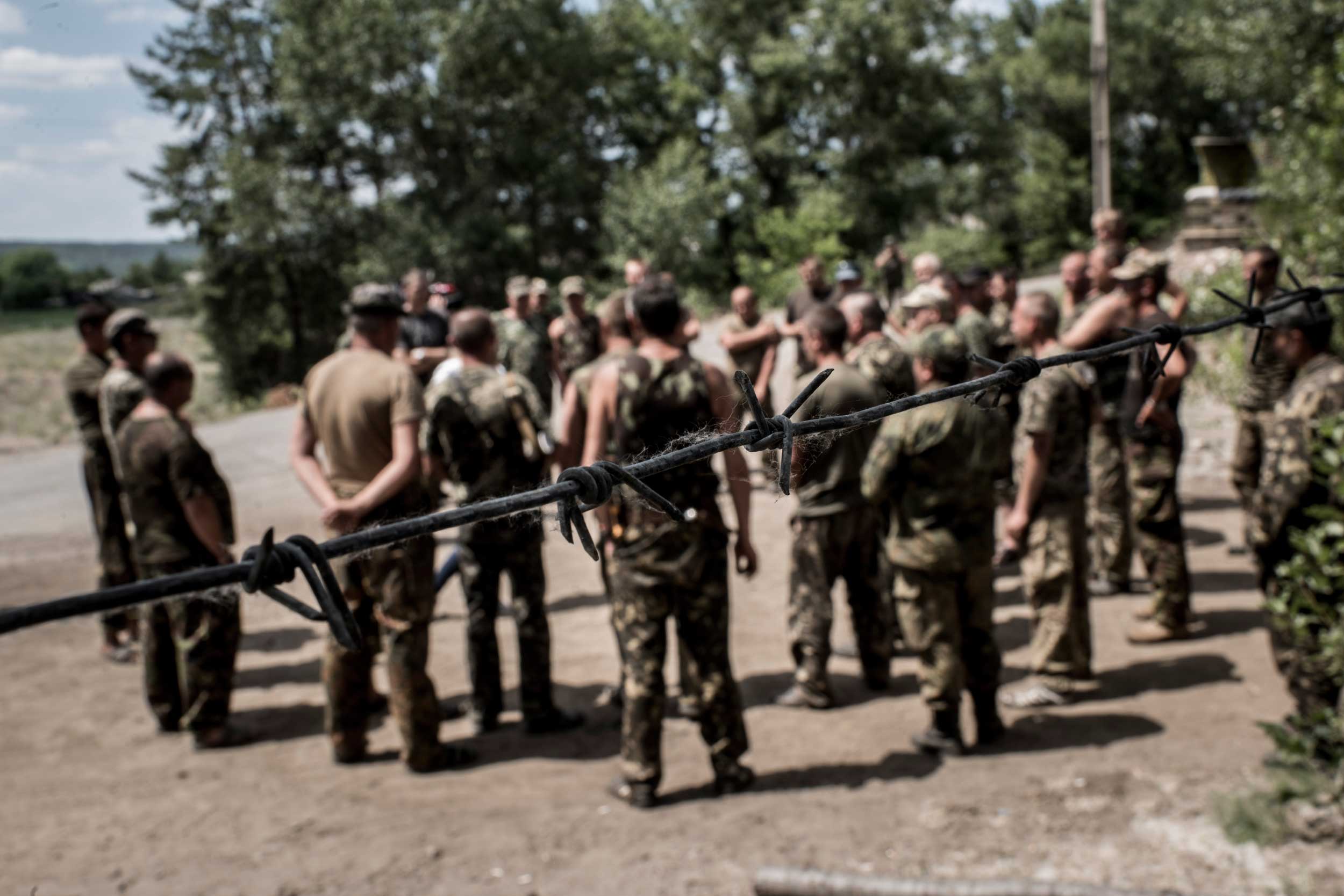 Ukrainian servicemen speak with their commander near a military base in Raygorodka village, Luhansk region, eastern Ukraine, June 13, 2015.