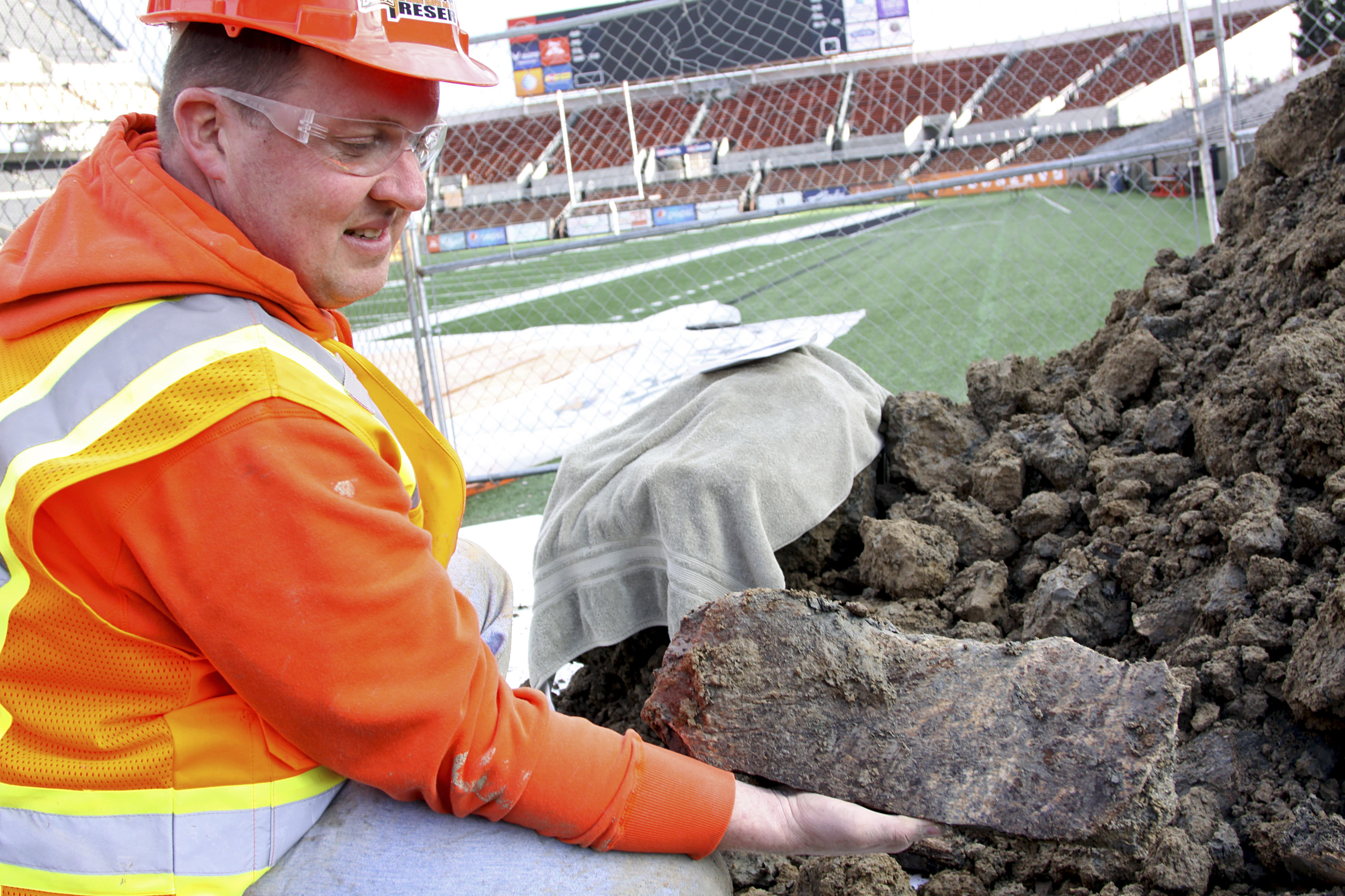 In this Jan. 26, 2016 photo provided by Oregon State University, Woodburn High School science teacher Dave Ellingson holds part of the pelvis of a mammoth found at an OSU construction site by a football field in Corvallis, Ore. Crews working on an expansion around Reser Stadium found a femur from one of the ancient elephants and bones from a bison and camel, all dating back 10,000 years. A spokesman says the OSU archaeologist believes the 10-foot pit where the remains were found could have been a pond or watering hole. (Theresa Hogue/Oregon State University via AP) (Theresa Hogue—AP)