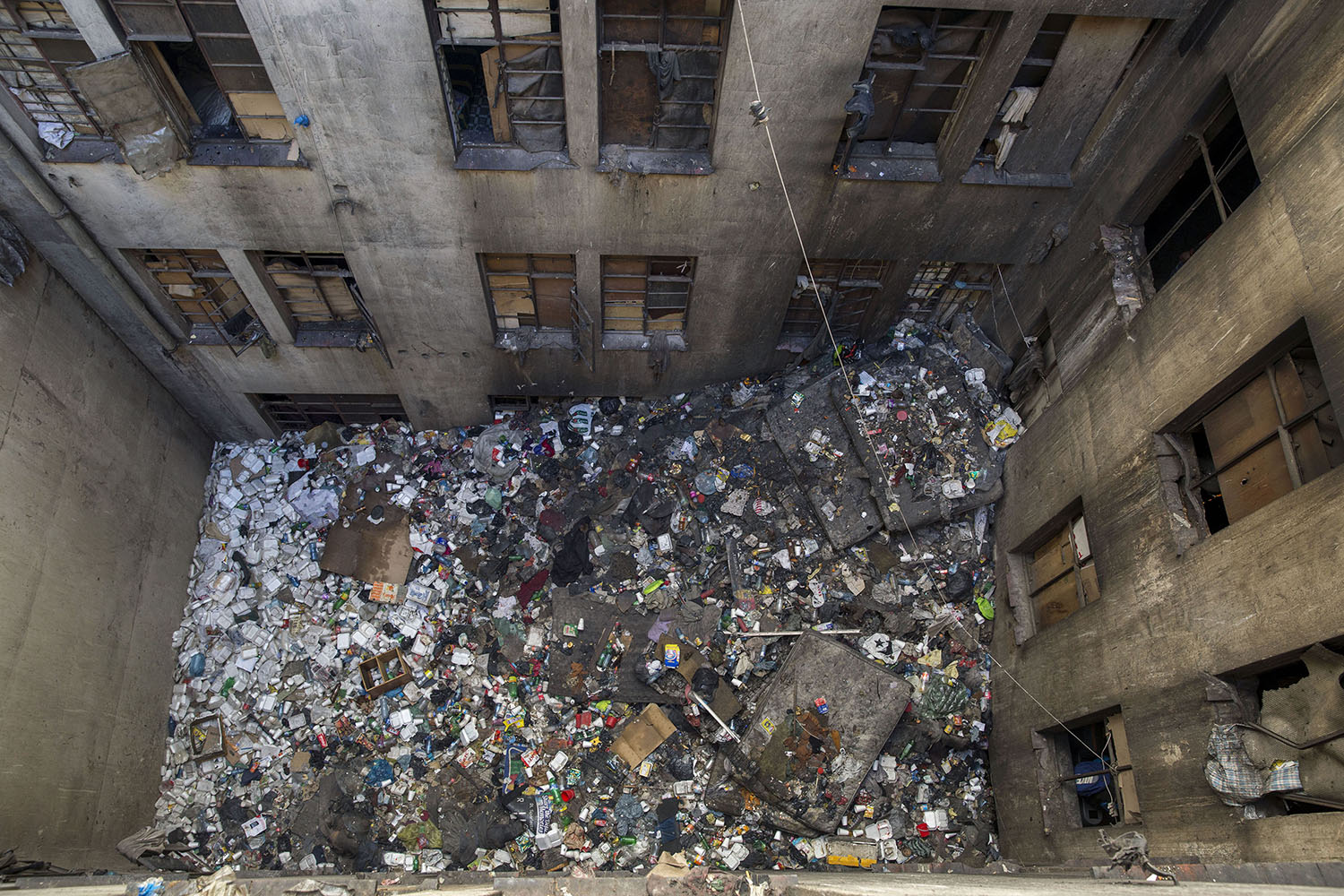 Aerial view of the rubbish filled courtyard at one of the derelict 'hijacked' buildings, Aug. 2, 2015.