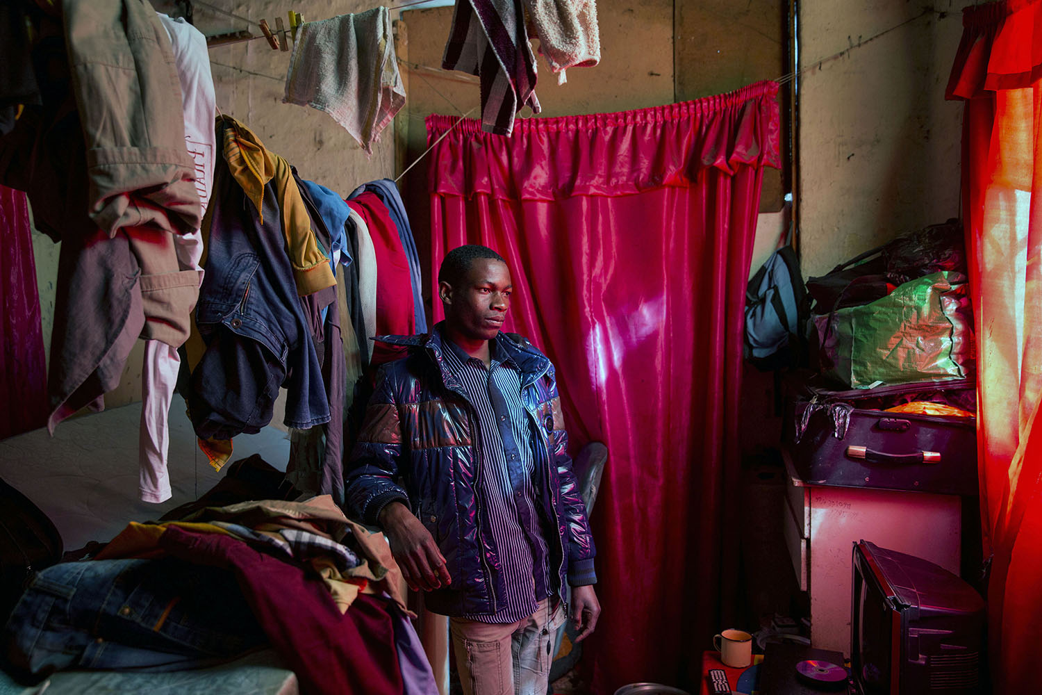 Edward (20 years), a carpenter from Malawi in his small room he shares with four other migrants, July 12, 2015.